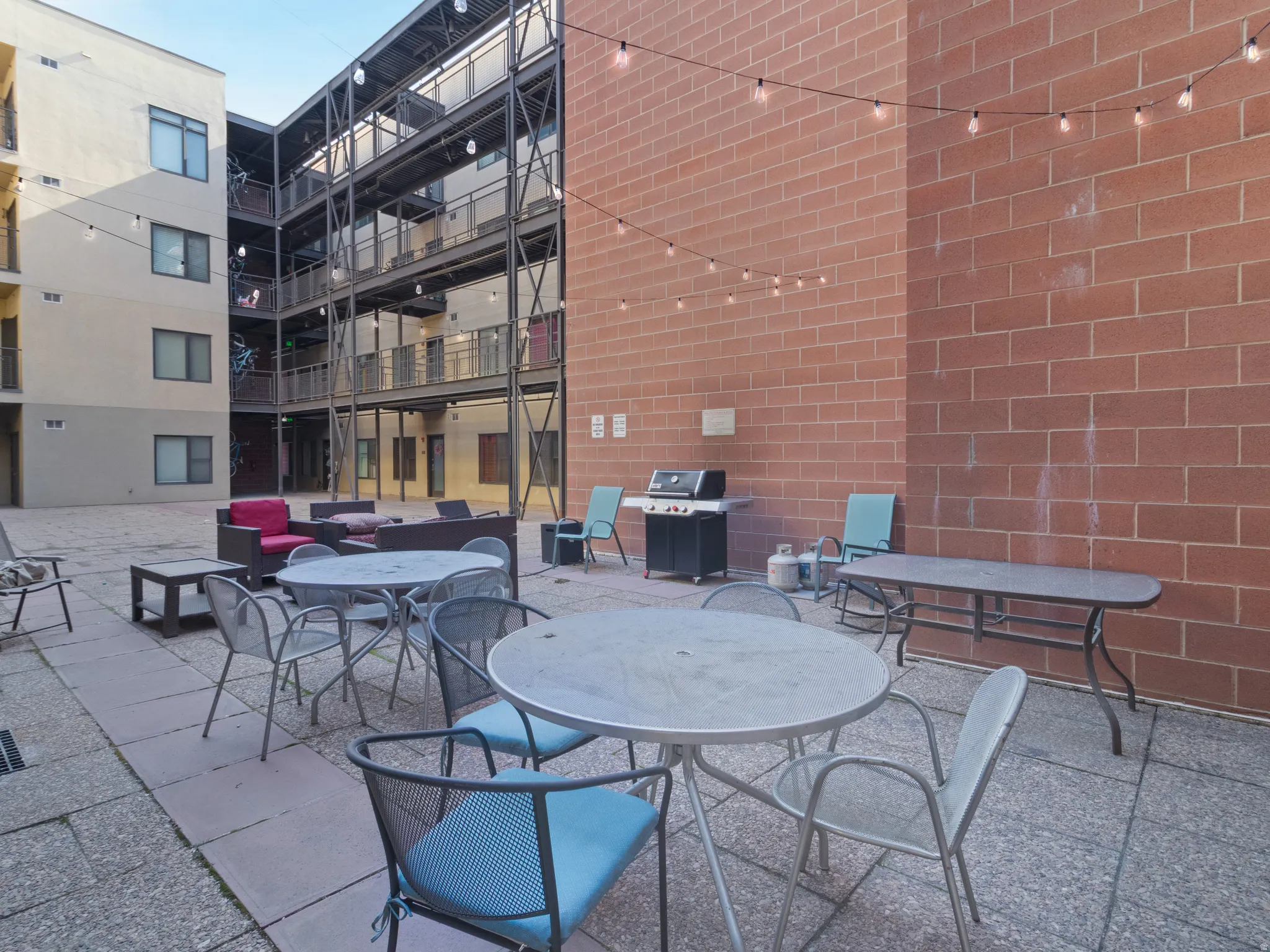 Expansive communal patio featuring paving stones and string lighting