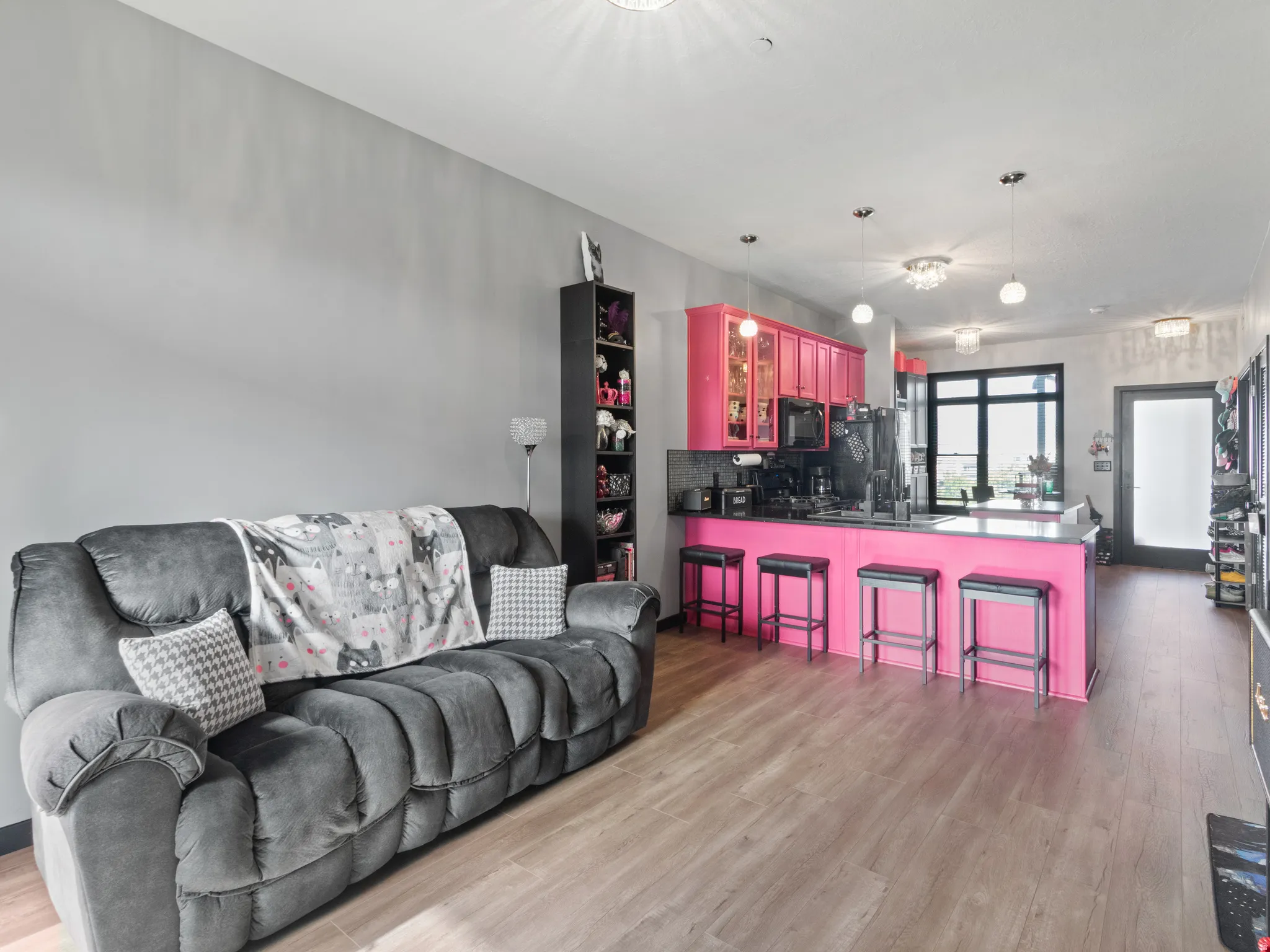 Spacious open-concept interior featuring light wood-finish flooring