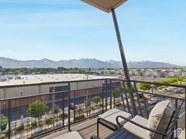 Private balcony featuring a metal railing and expansive mountain backdrop