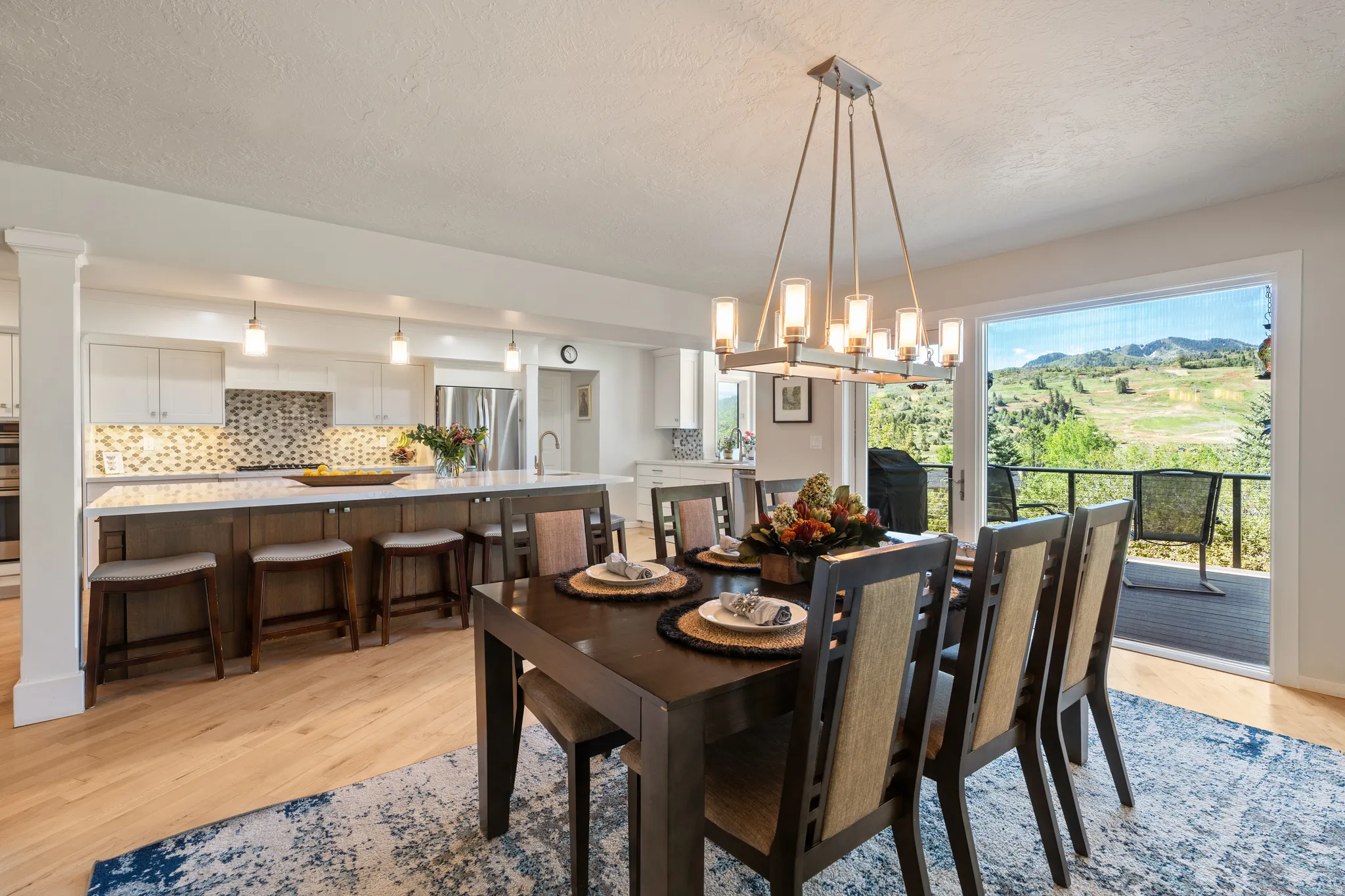 Open-concept kitchen and dining area featuring light wood-finish flooring
