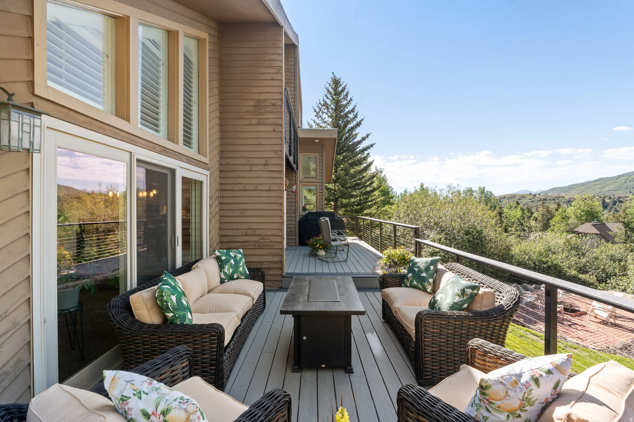 Spacious outdoor deck with composite decking and cable railing system