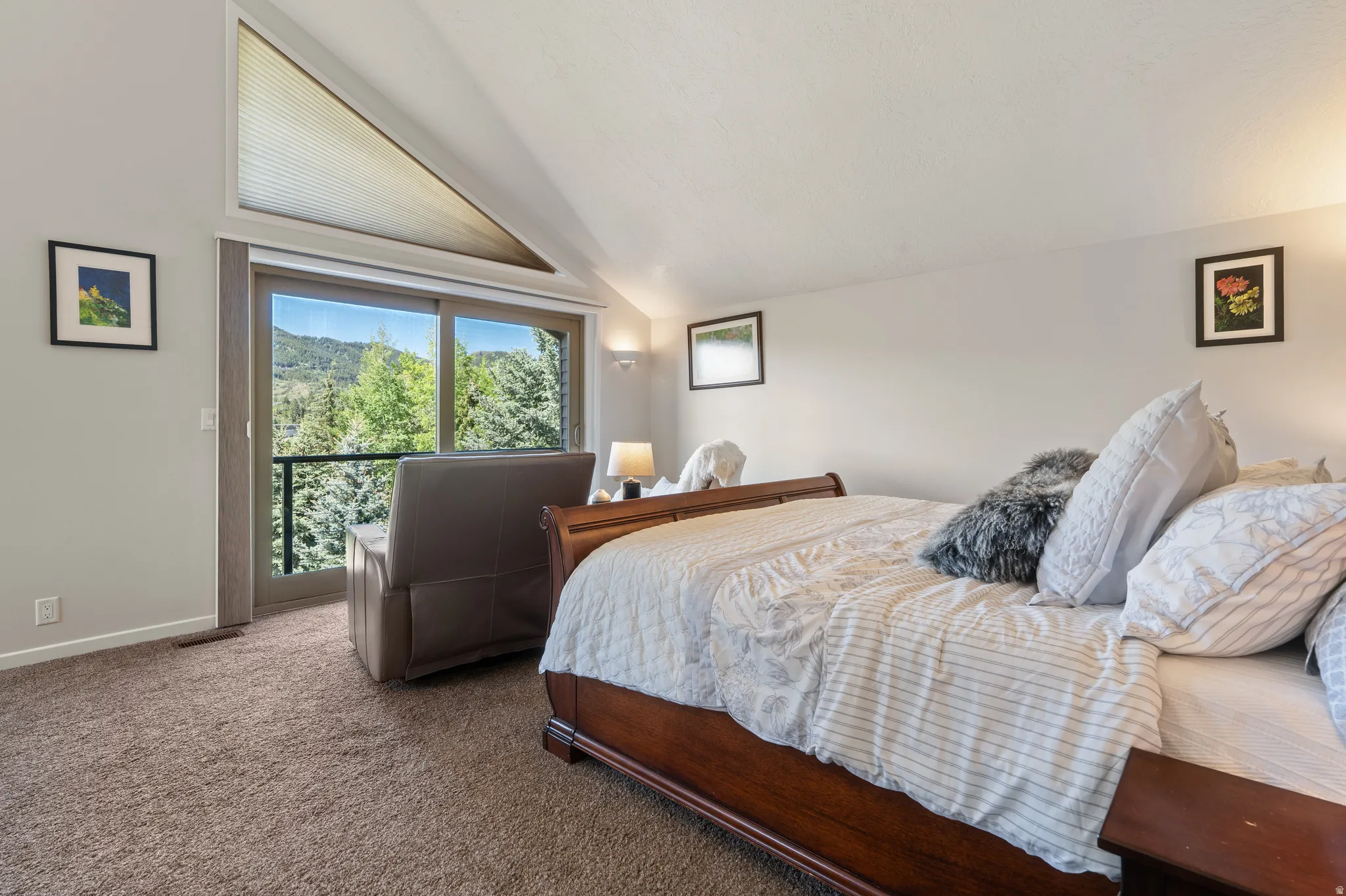 Sloped ceiling interior with a sliding glass door and triangular transom window