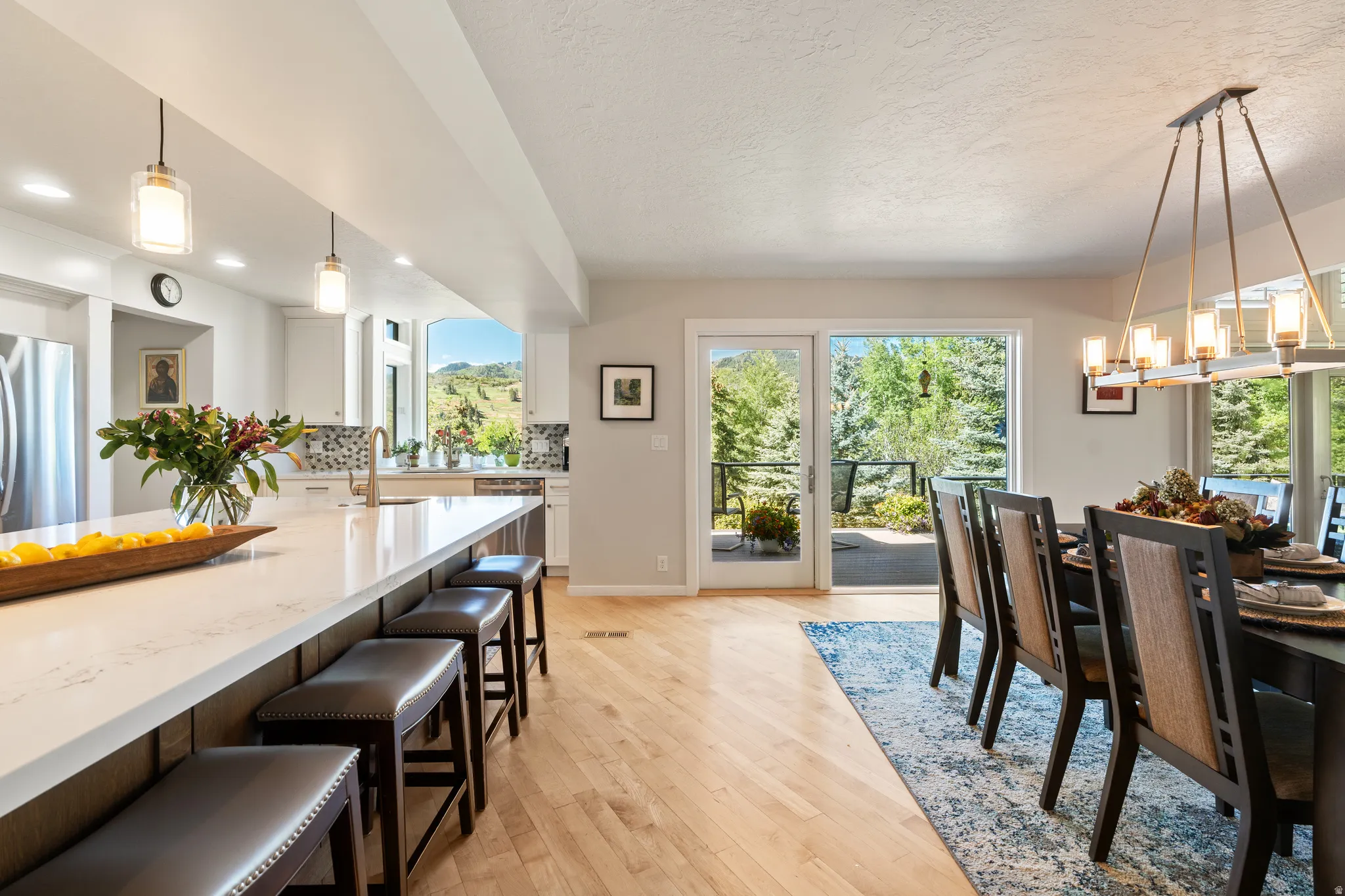 Open-concept kitchen and dining area featuring light wood-finish flooring