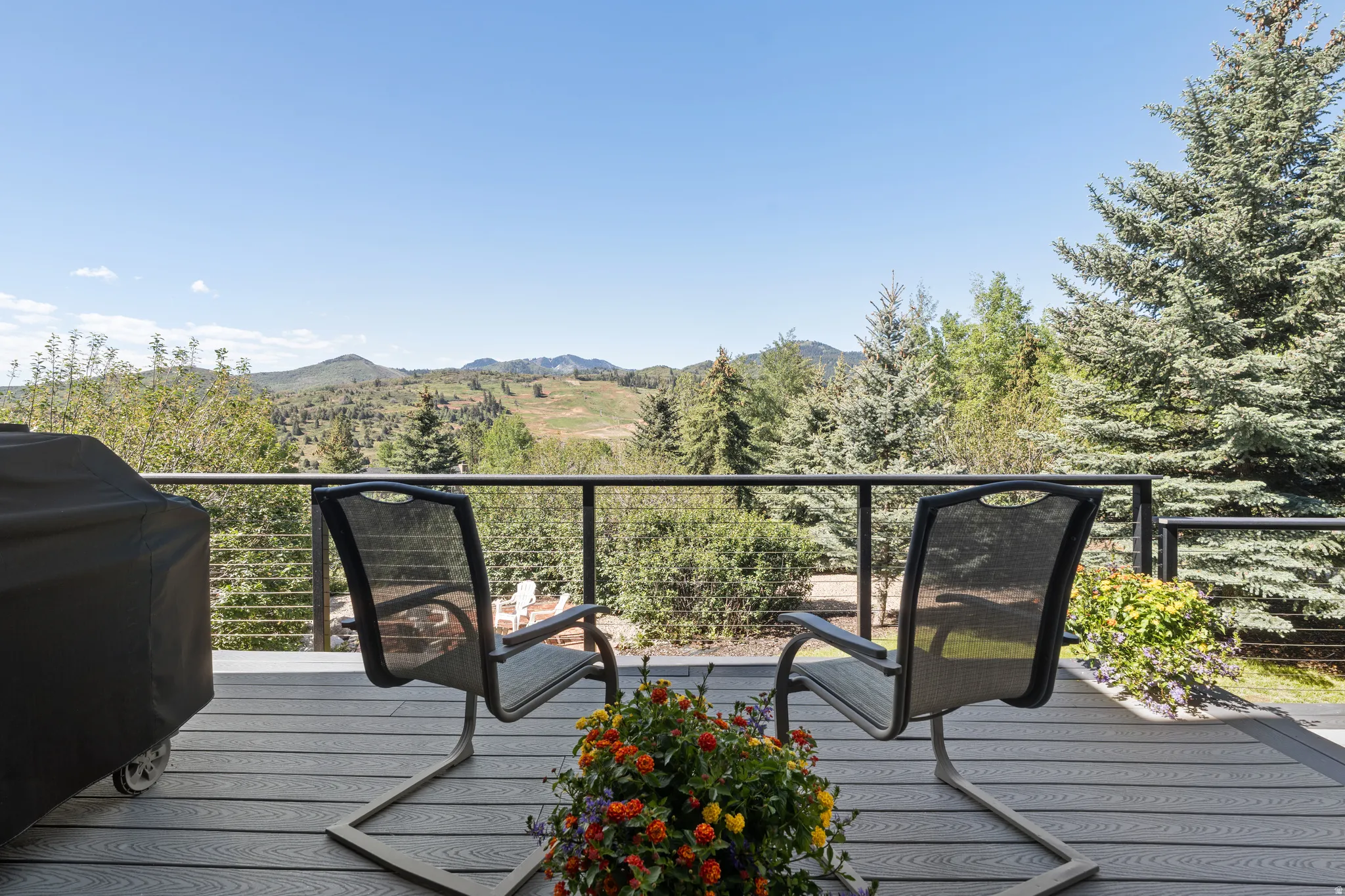 Expansive outdoor deck with composite decking and a cable railing system