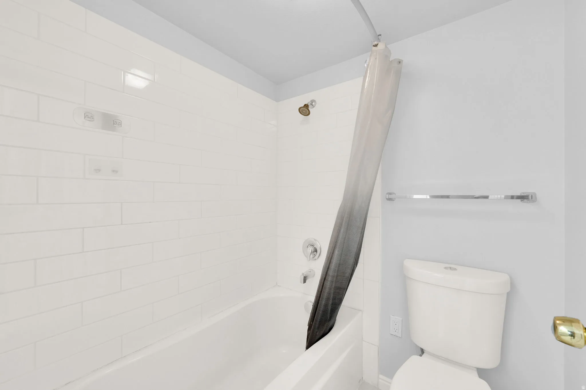 White subway tile surround in the shower and tub combination