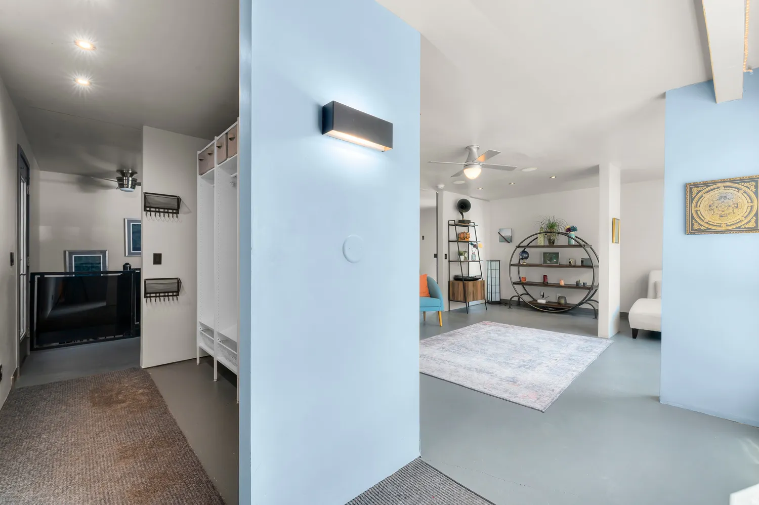 Open floor plan featuring light blue accent walls and recessed lighting