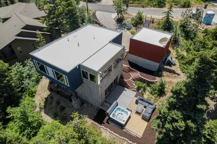 Contemporary multi-level exterior with flat rooflines, a private outdoor patio, and a separate detached structure