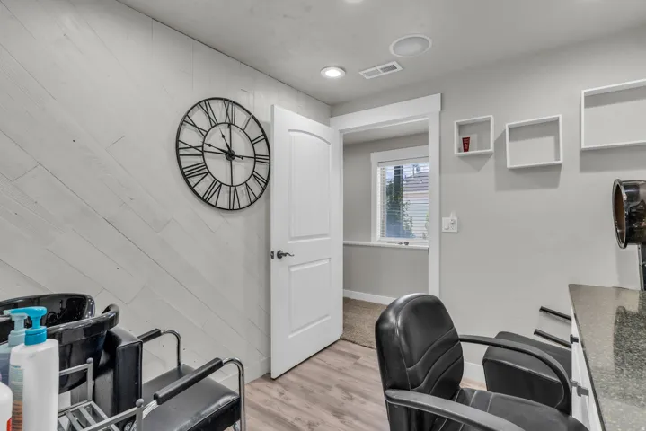 Light wood-finish flooring complements the horizontally paneled accent wall
