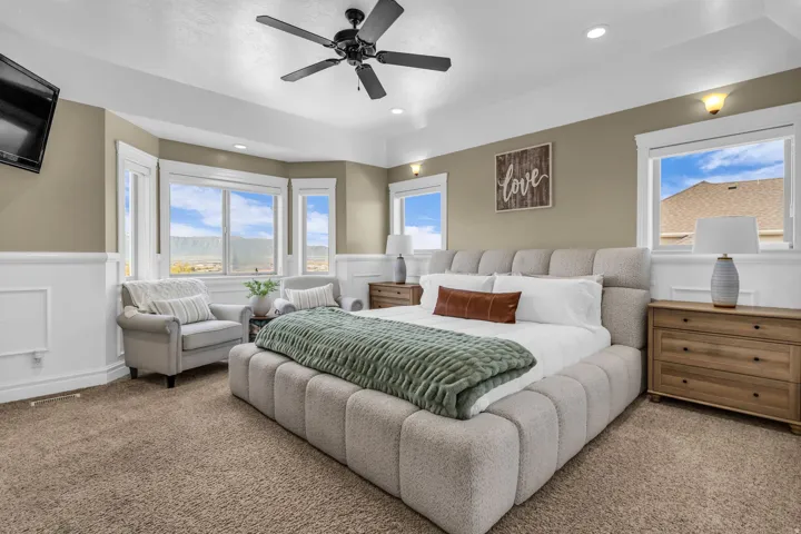 Spacious room featuring a tray ceiling, recessed lighting, and a ceiling fan