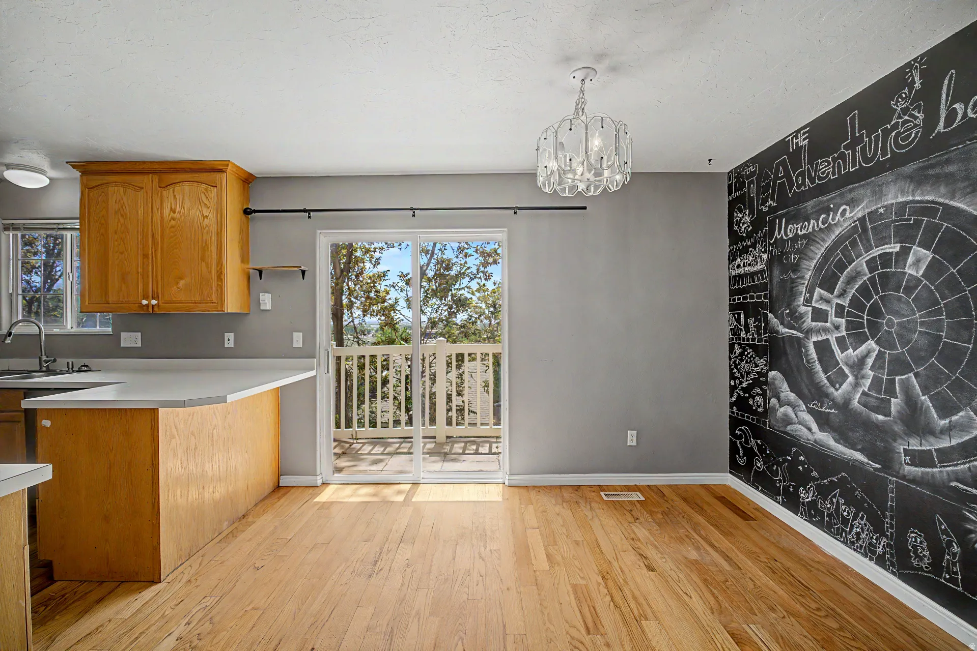 Hardwood flooring throughout, with a chalkboard accent wall