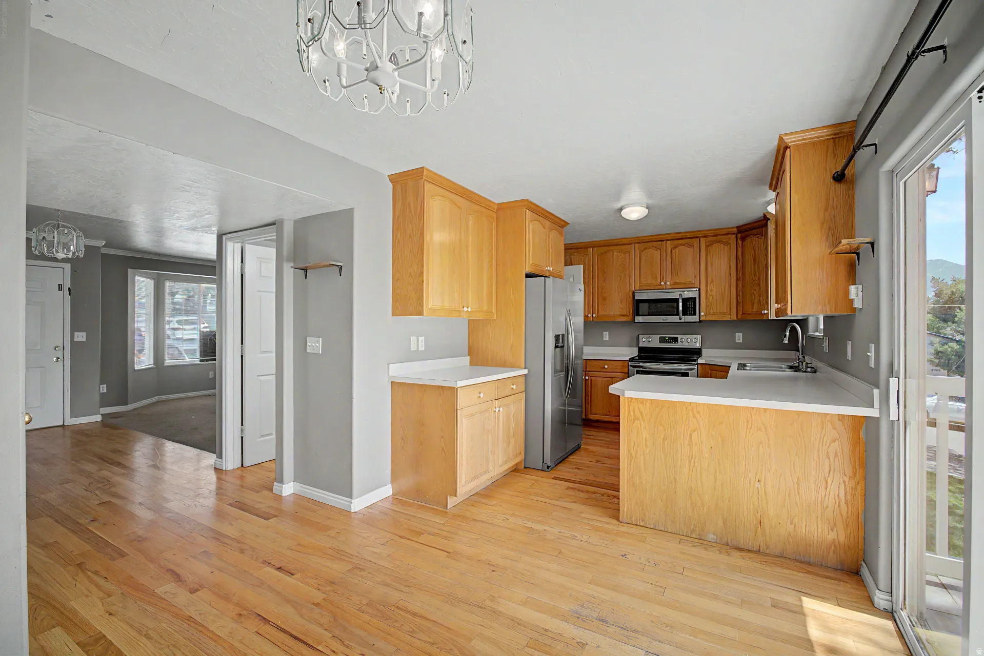 Kitchen featuring wood cabinetry, stainless steel appliances, and light-toned countertops