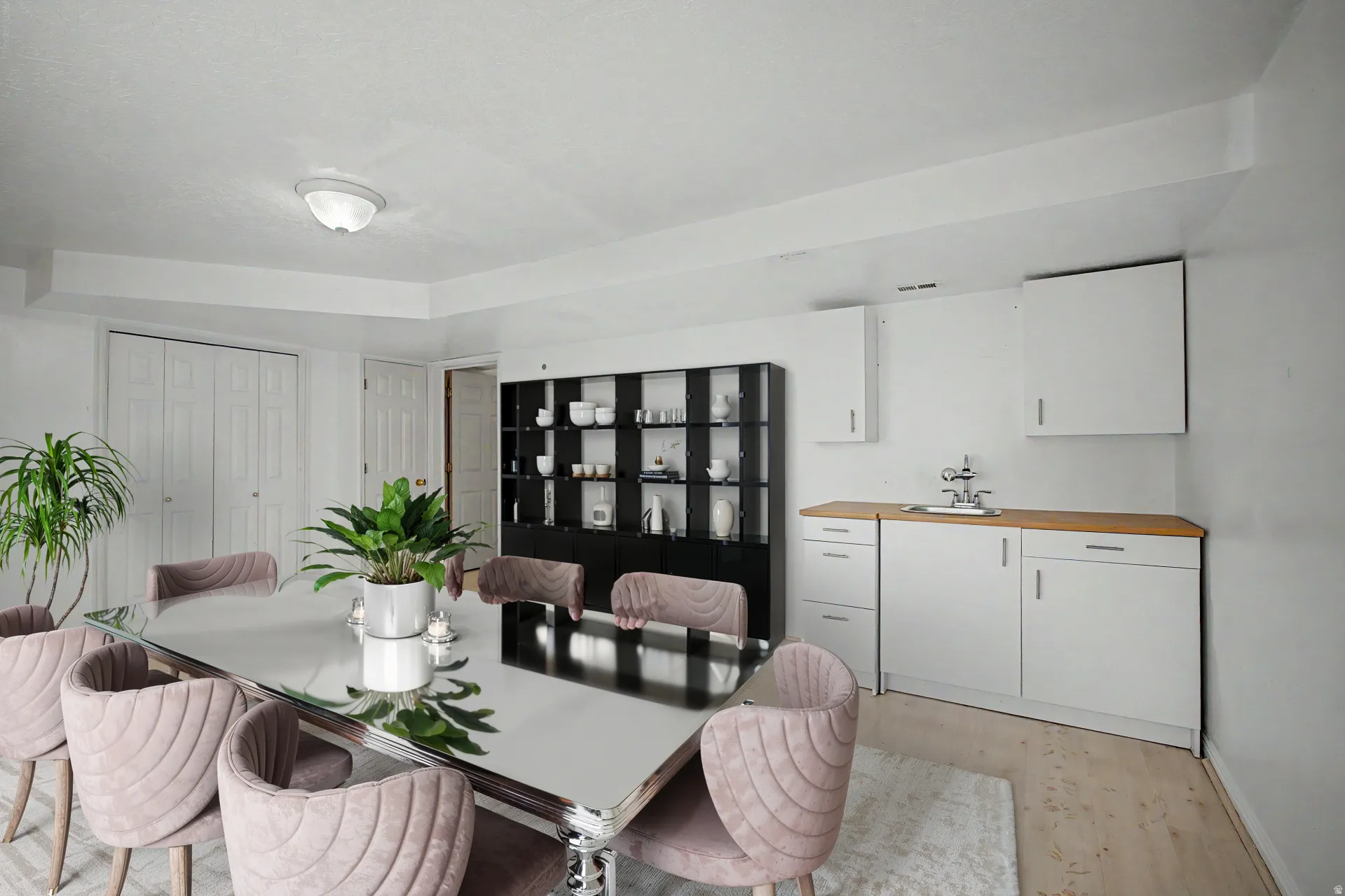 Virtually staged Dining area featuring a built-in wet bar with white cabinetry, a wood-finish countertop, and a stainless steel sink