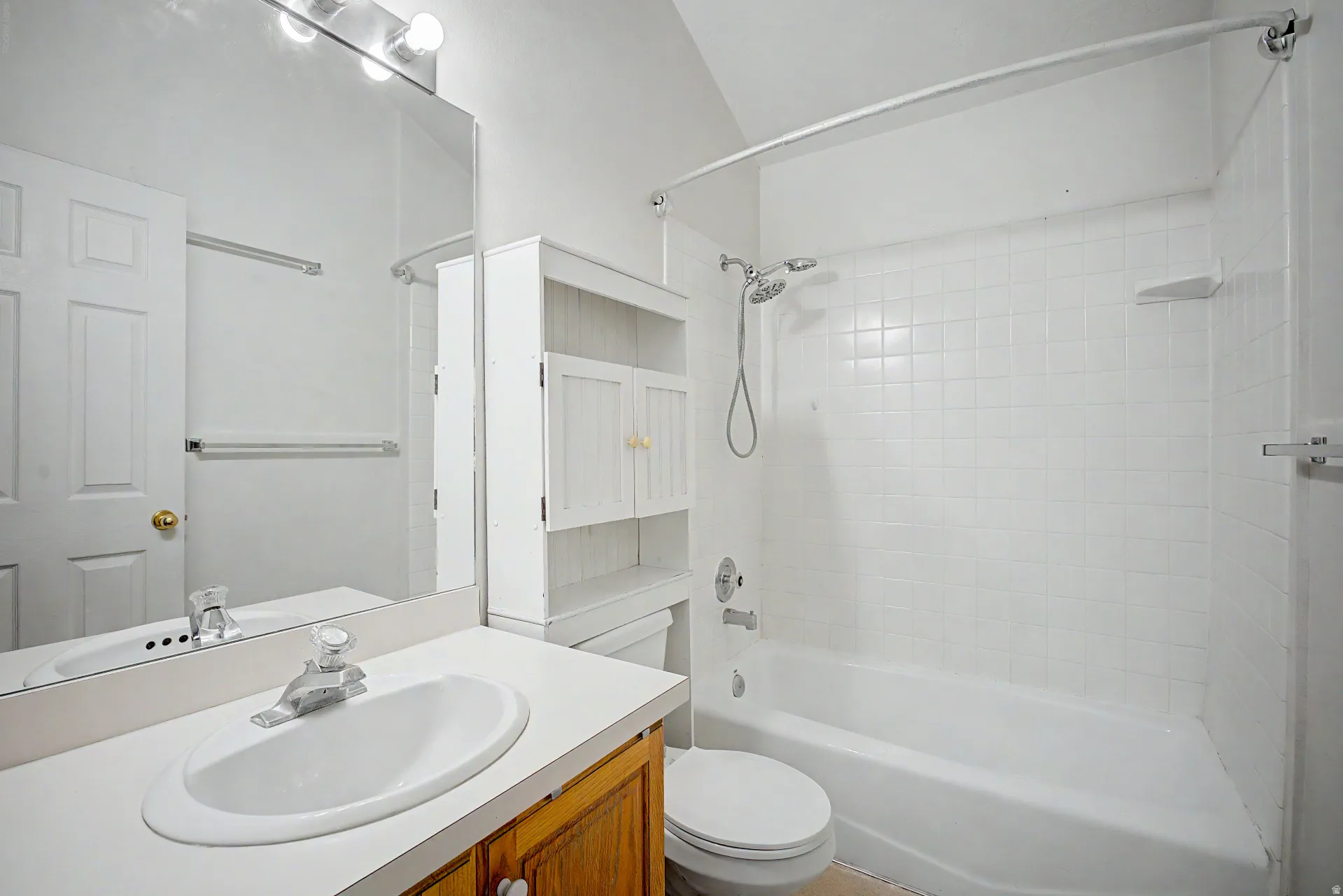 Bathroom featuring a built-in vanity with a laminate countertop and white oval sink