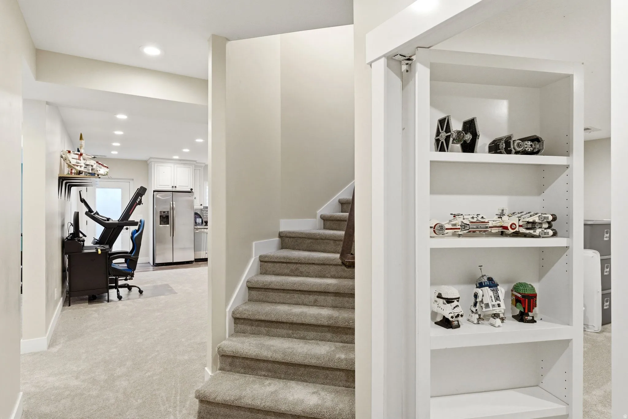 Carpeted staircase with white risers and a built-in shelving unit