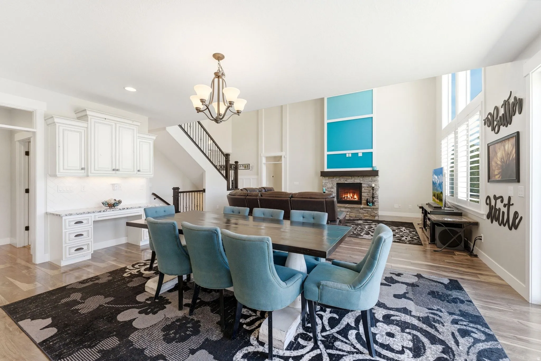 Open-concept living space featuring high ceilings and wood-finish flooring