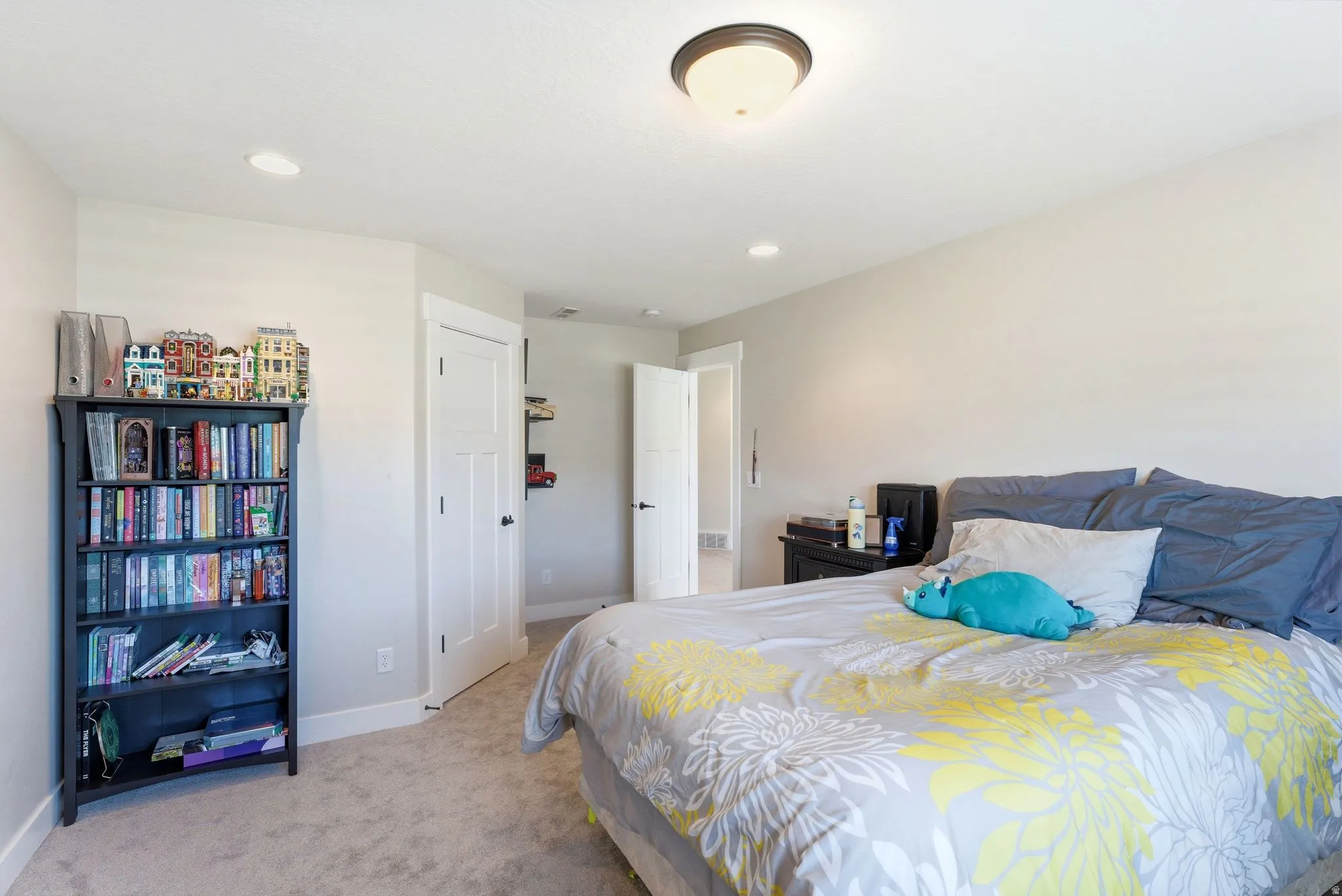 Carpeted room featuring light neutral wall tones and white baseboards
