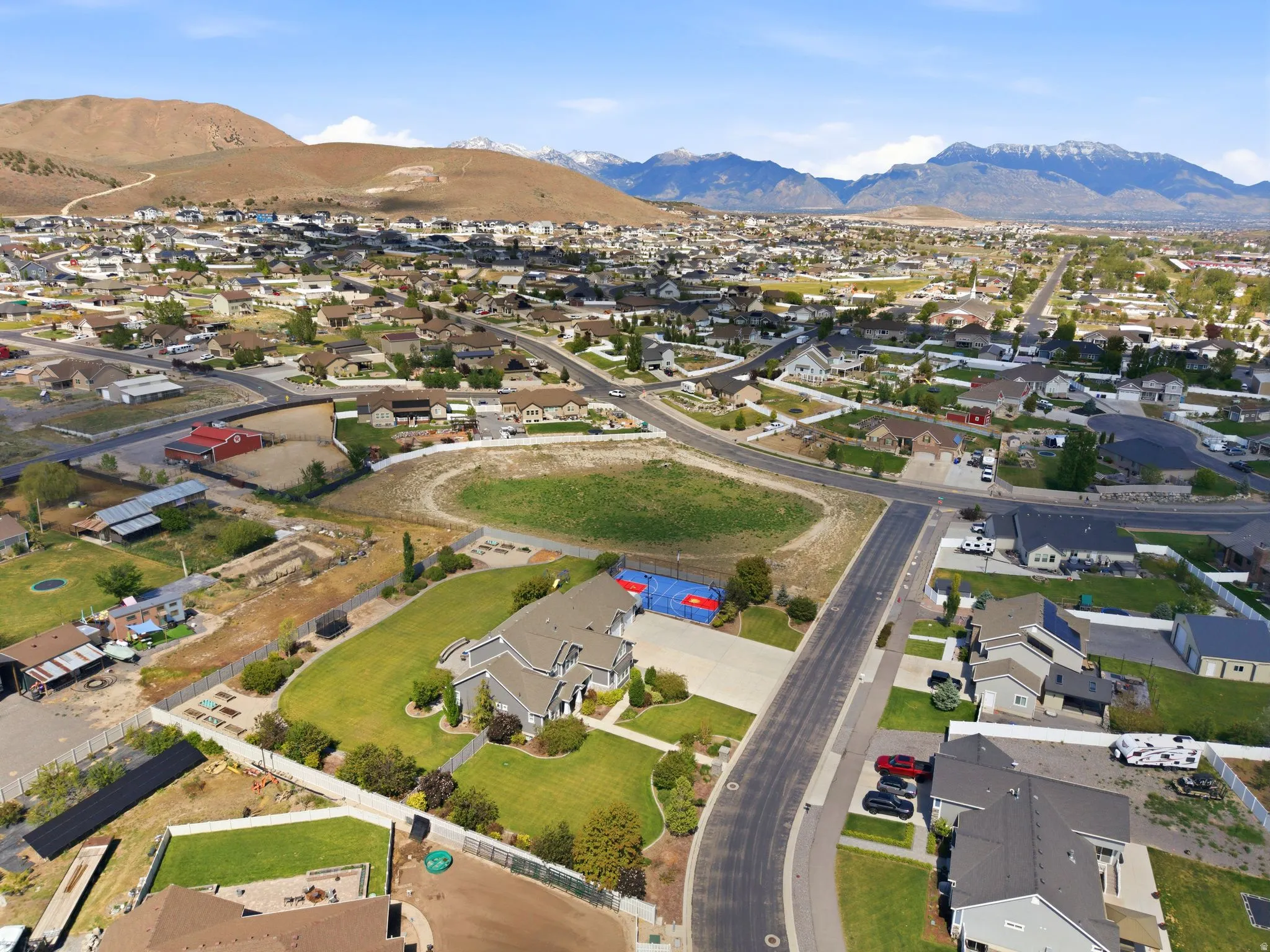 Aerial perspective showcasing a residential neighborhood with distant mountains