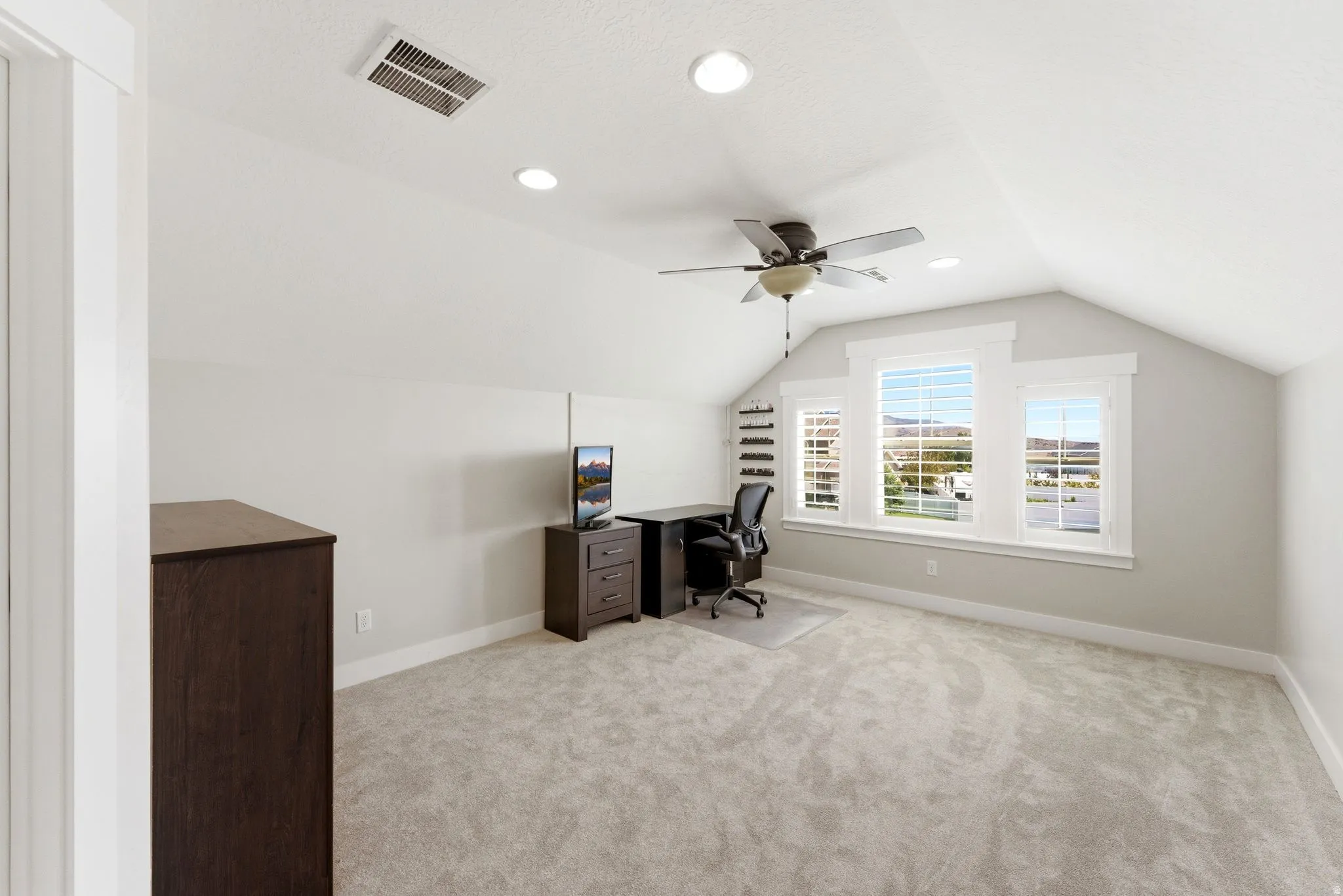 Attic room featuring recessed lighting, a ceiling fan, light gray carpet flooring, and a triple window with white louvered blinds