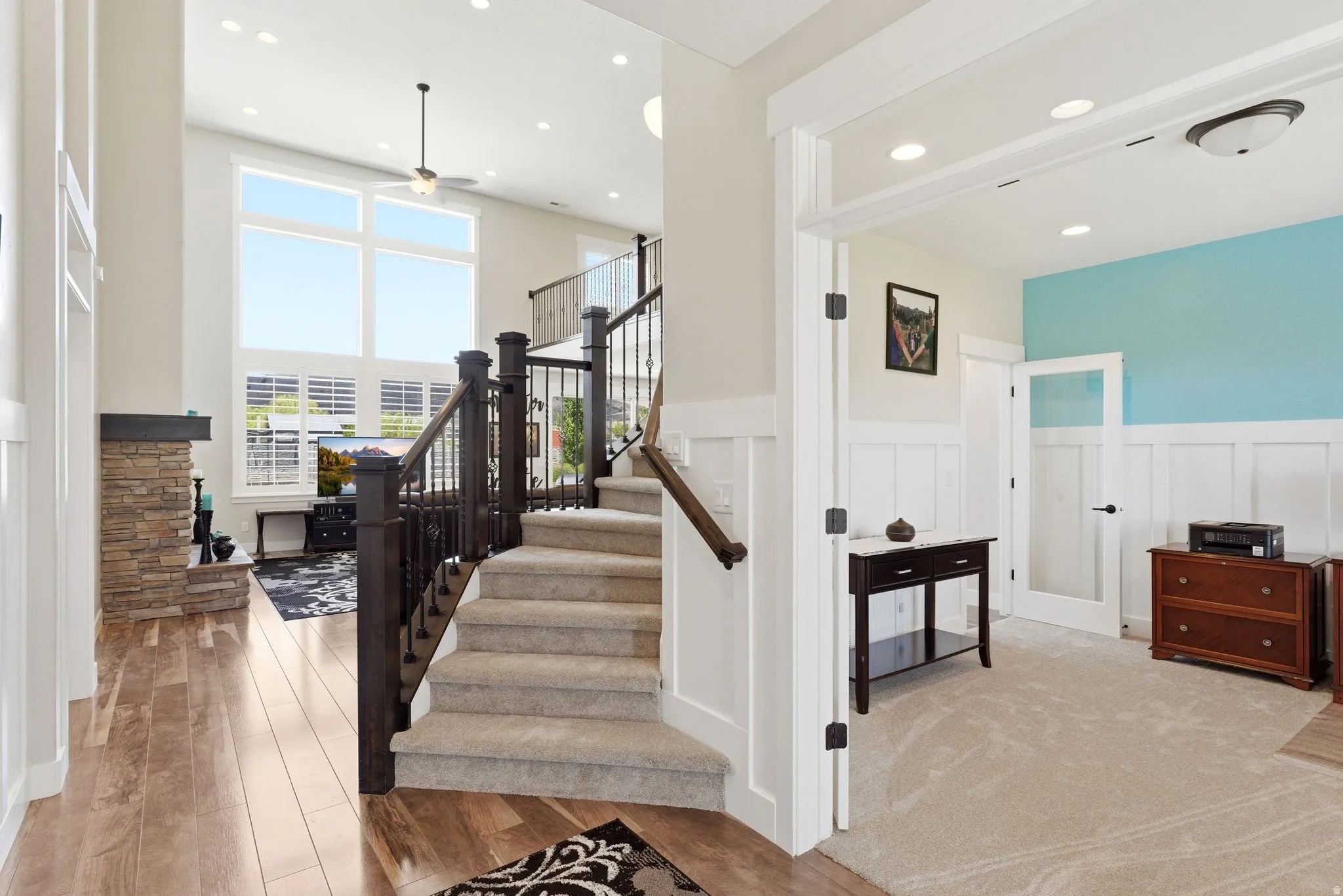 Carpeted staircase with dark wood newel posts and railings