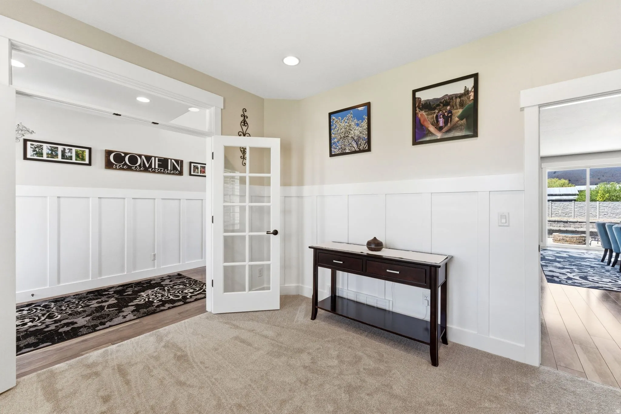 Entryway featuring carpet flooring and board and batten wainscoting