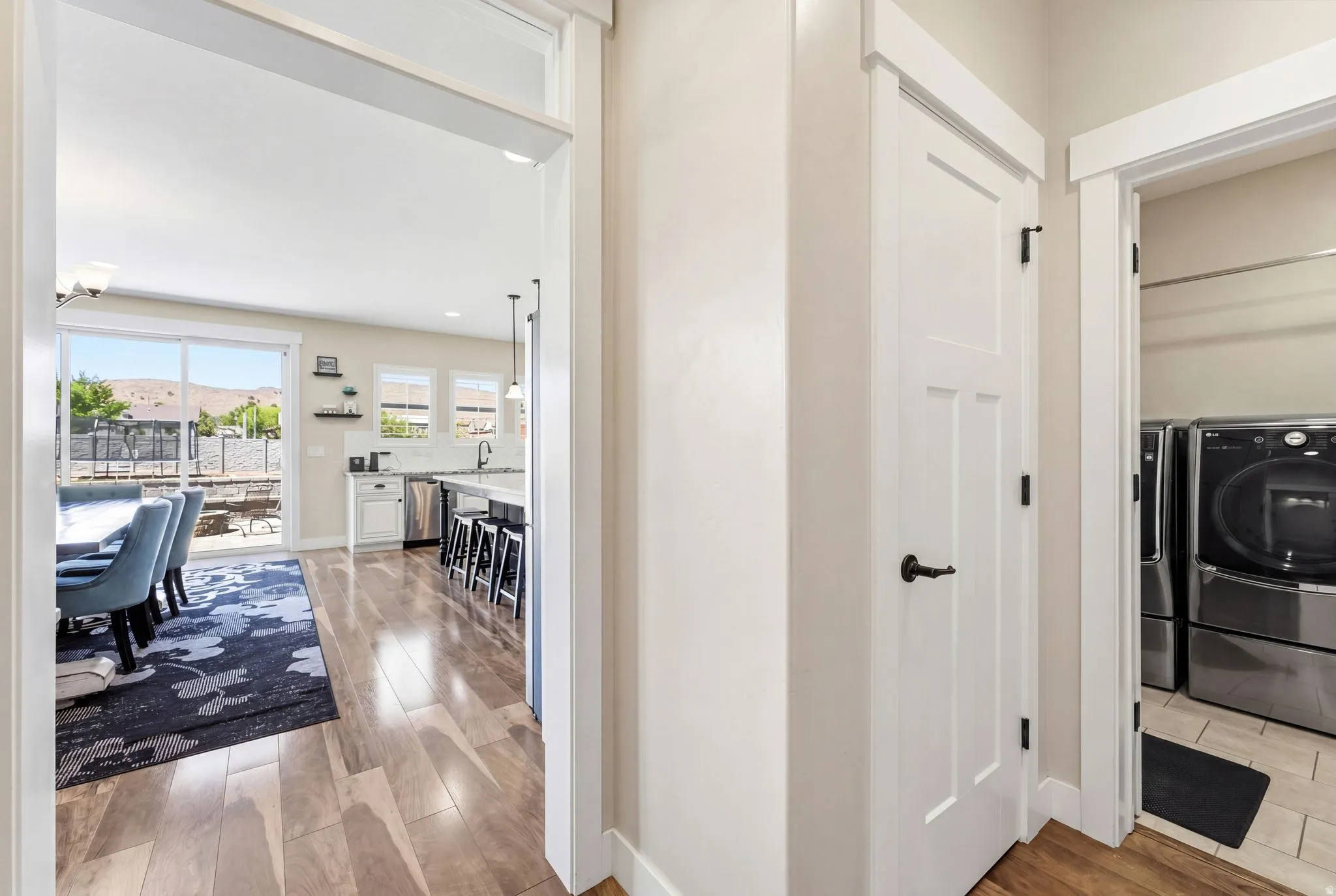 Hardwood-finish flooring extending from the hallway into an open-concept living area