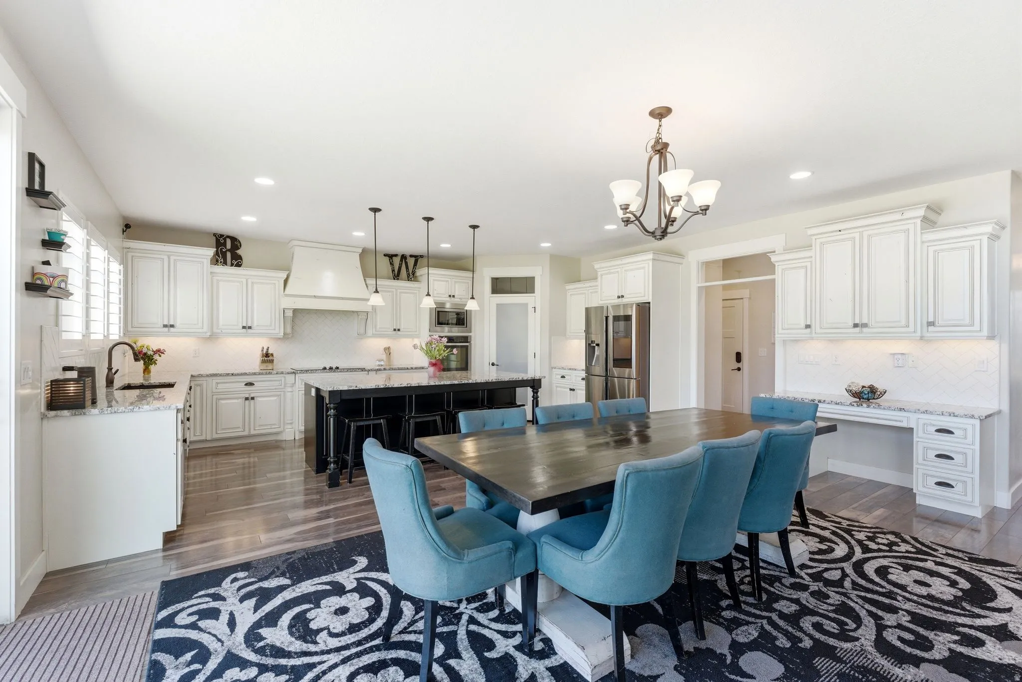 Open-concept kitchen and dining area featuring wood-finish flooring