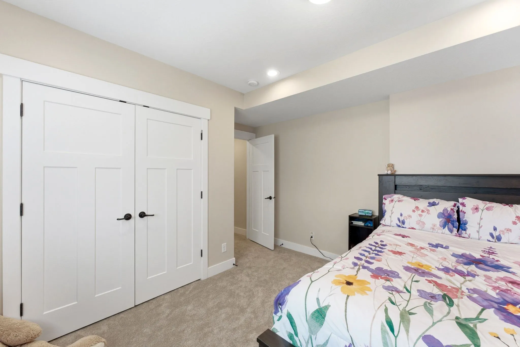 Bedroom featuring neutral wall paint, recessed lighting, white trim, and light grey carpeting