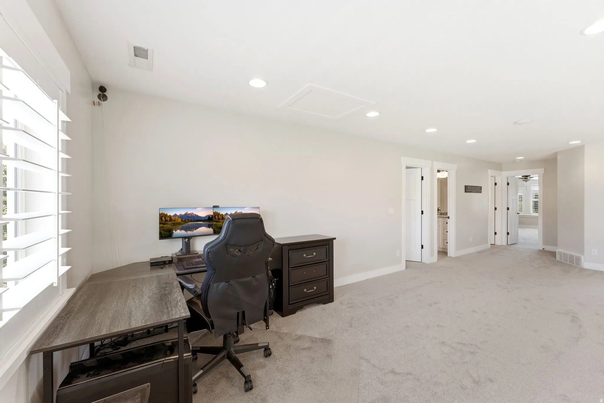 Spacious room with light-toned wall paint and plush carpeting