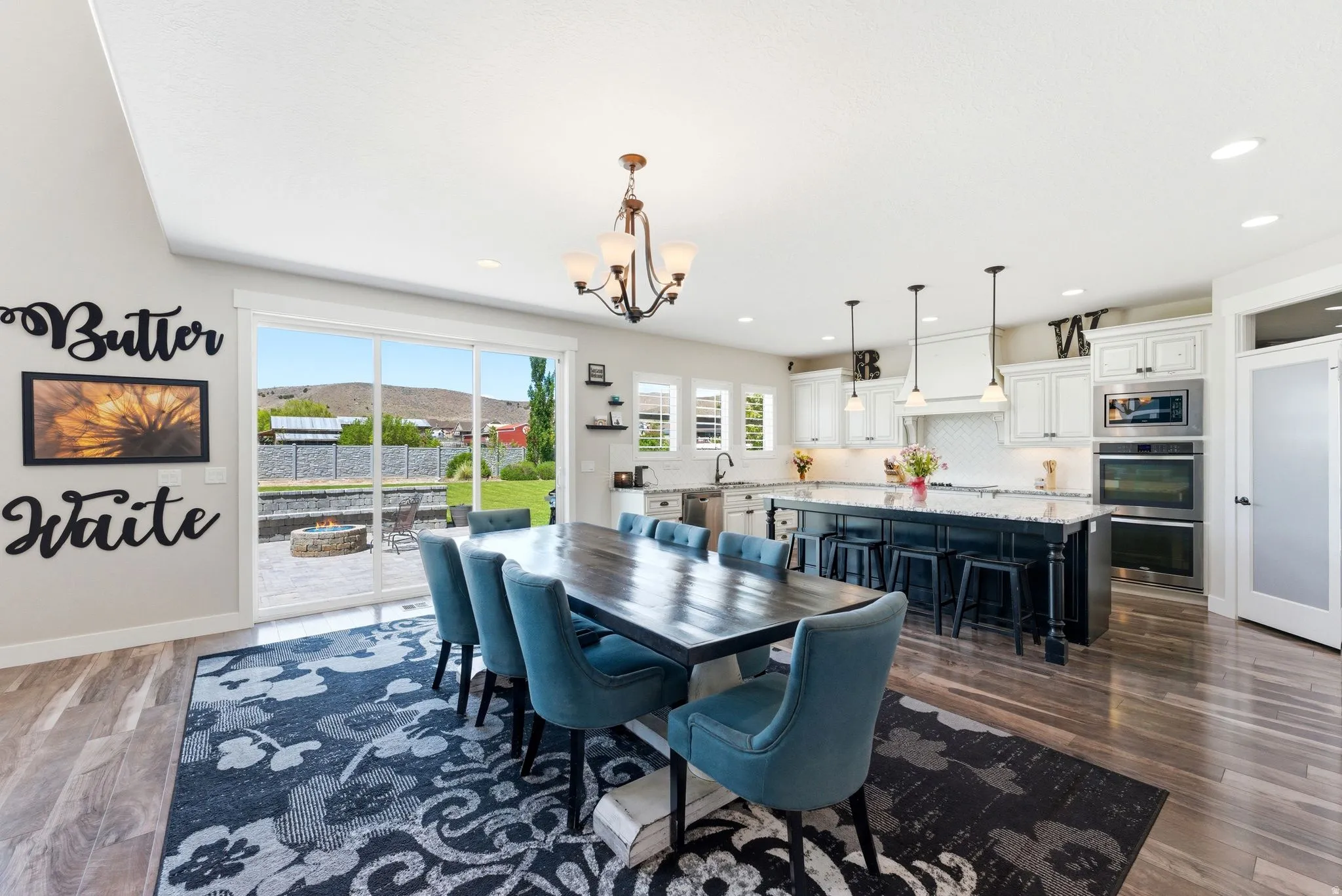 Spacious open-concept kitchen and dining area featuring wood-finish flooring