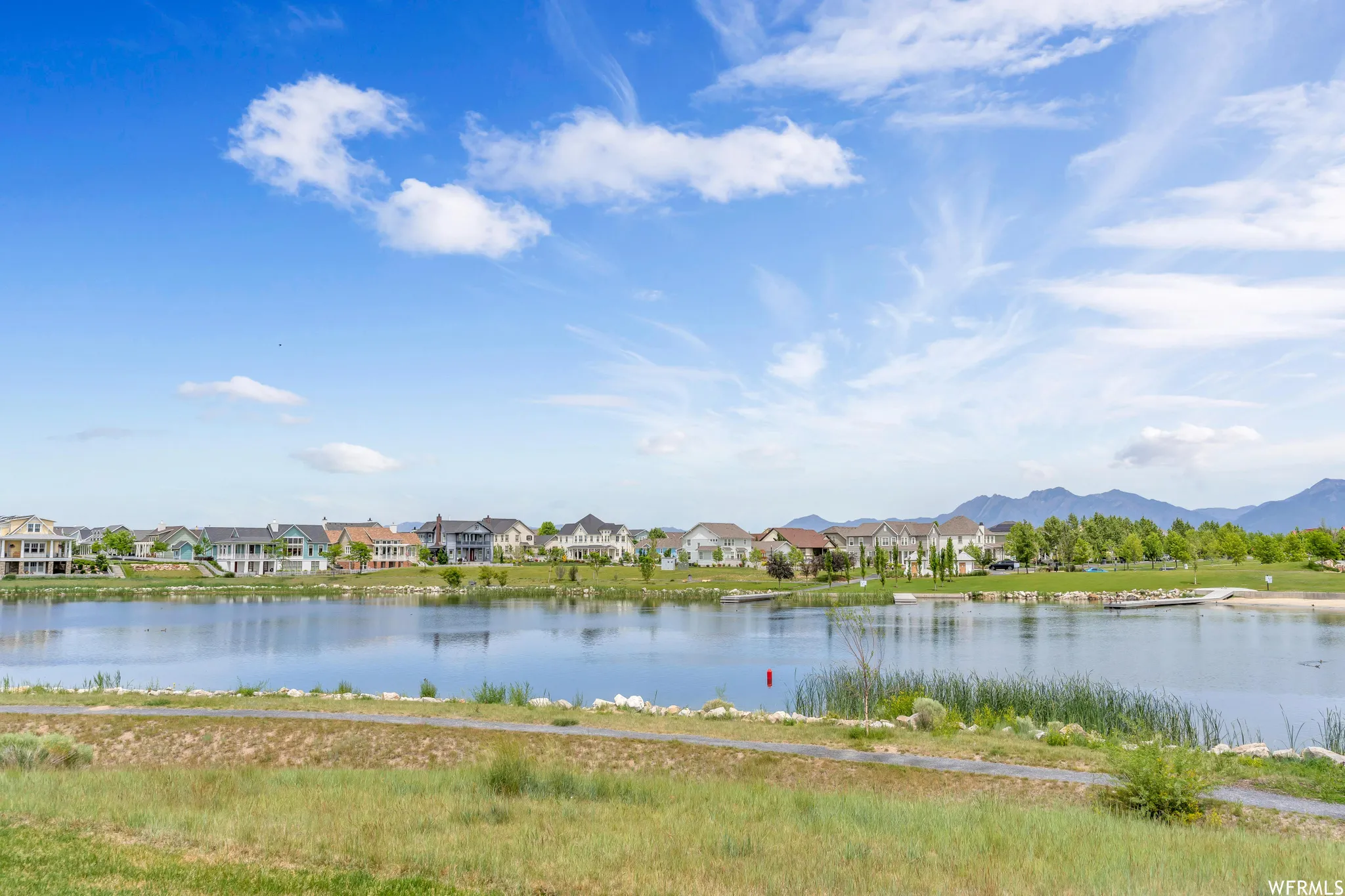 Expansive waterfront with a gravel path and green space