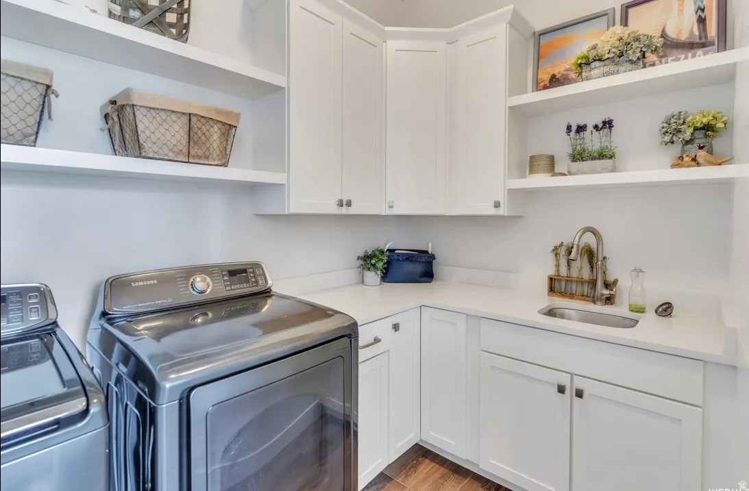 Dedicated utility space featuring white shaker-style cabinetry, a built-in sink, and extensive white countertops