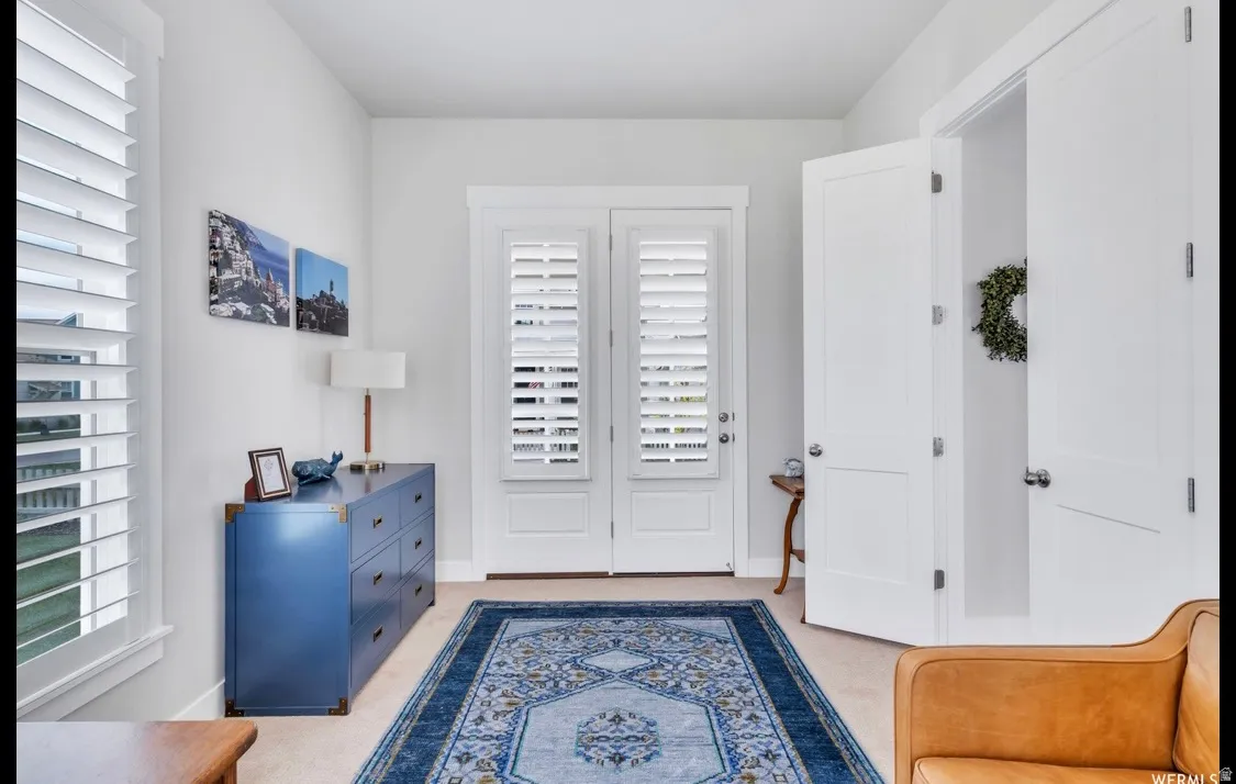 Double French doors with interior plantation shutters, flanked by an additional window with plantation shutters