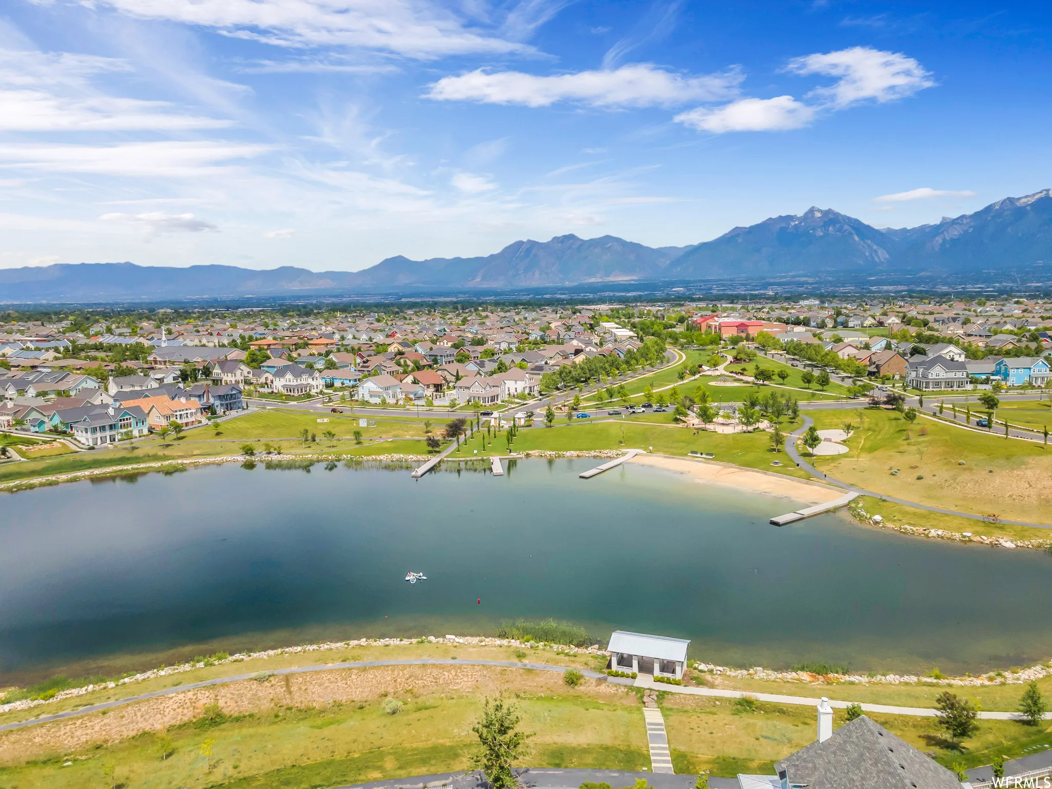 Aerial perspective showcasing a community with a central lake feature