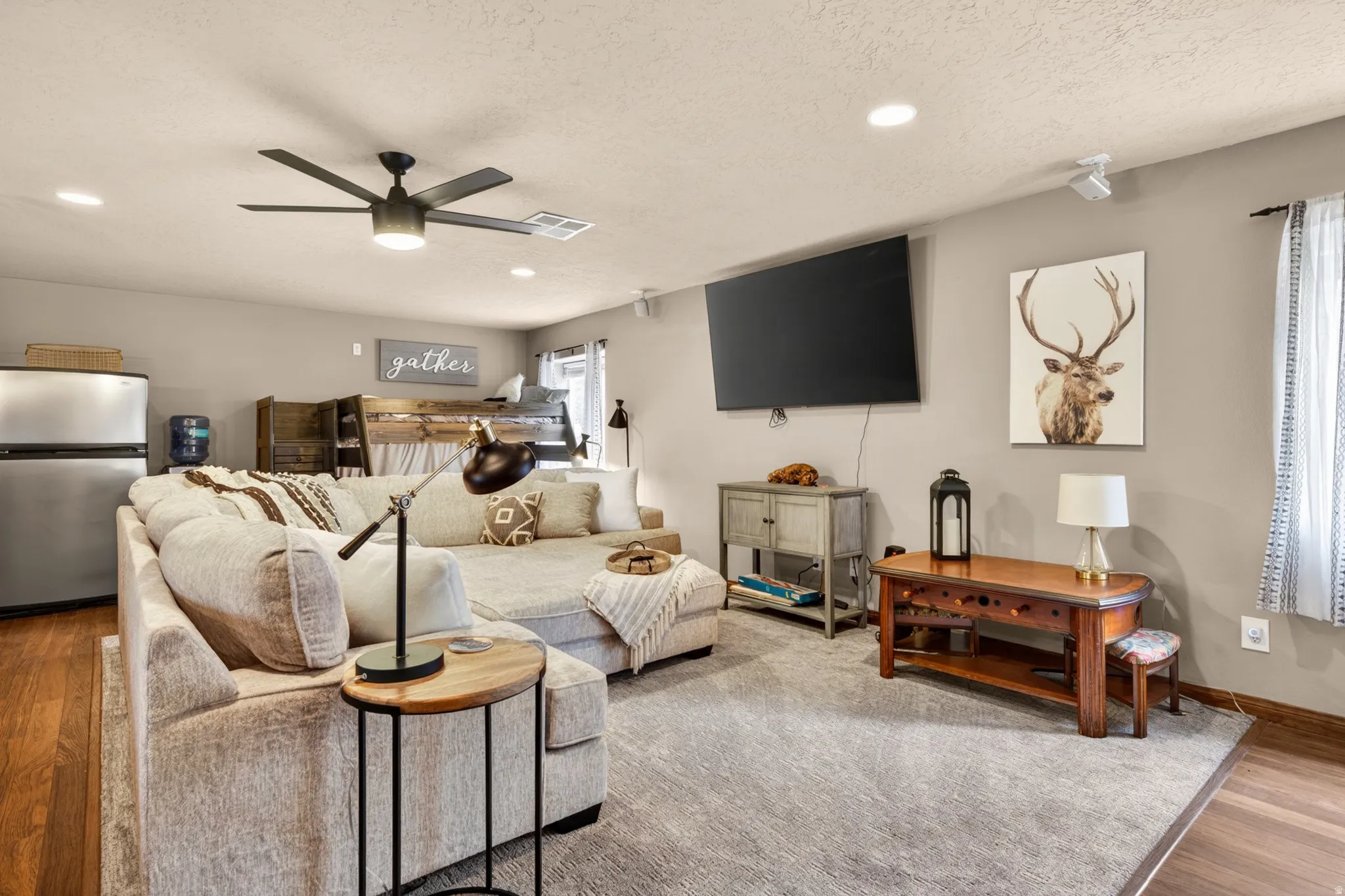 Open concept living area featuring wood-finish flooring, recessed lighting, and a ceiling fan