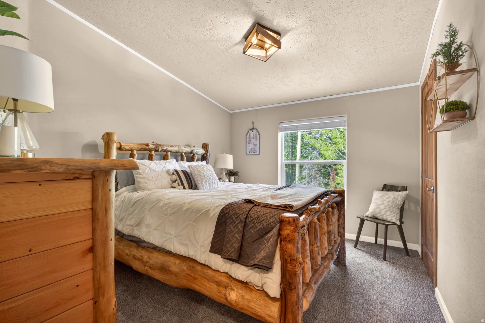 Room featuring neutral wall tones, textured ceiling, and a prominent window
