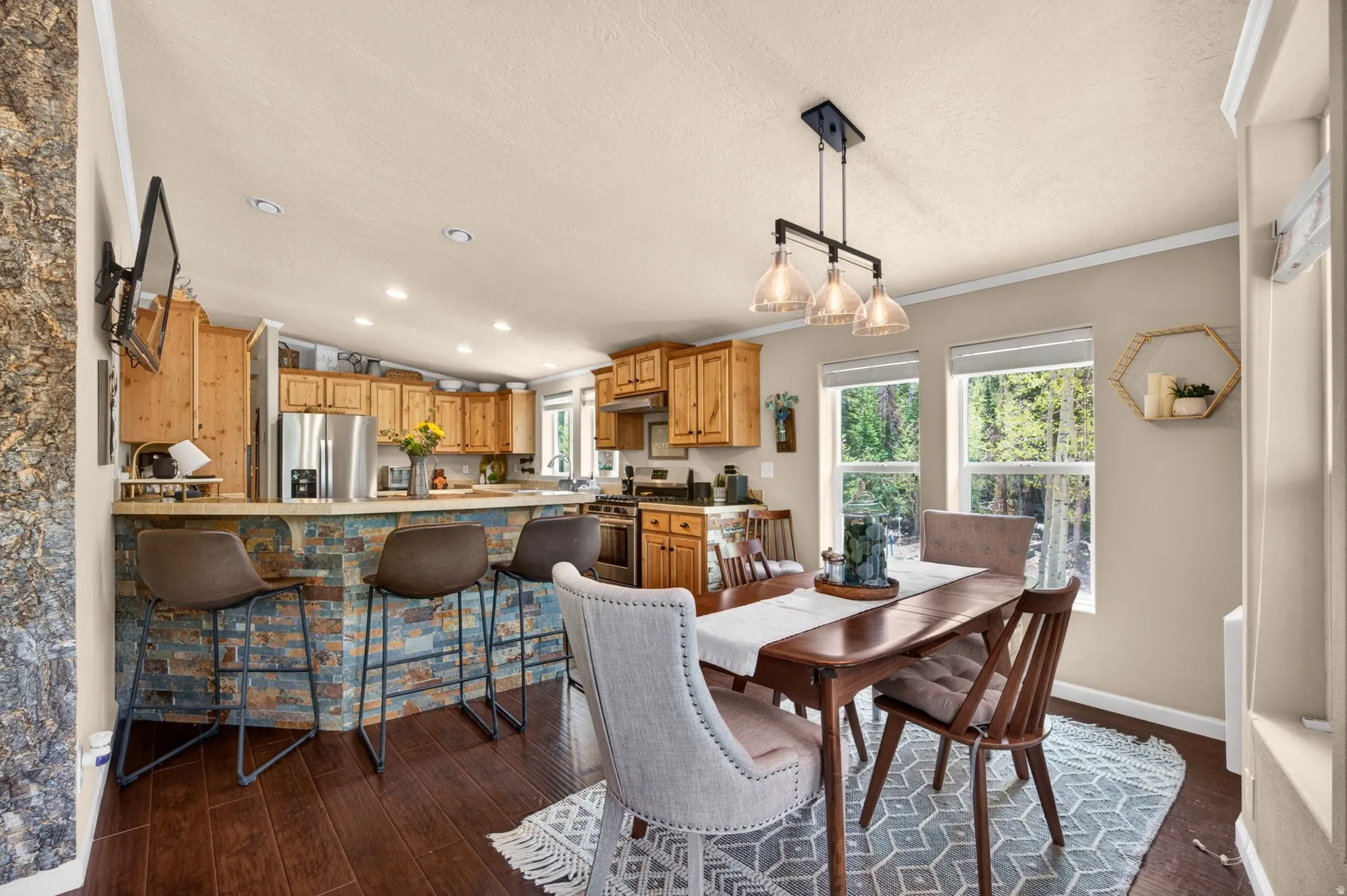 Open-concept kitchen and dining area featuring wood-finish flooring