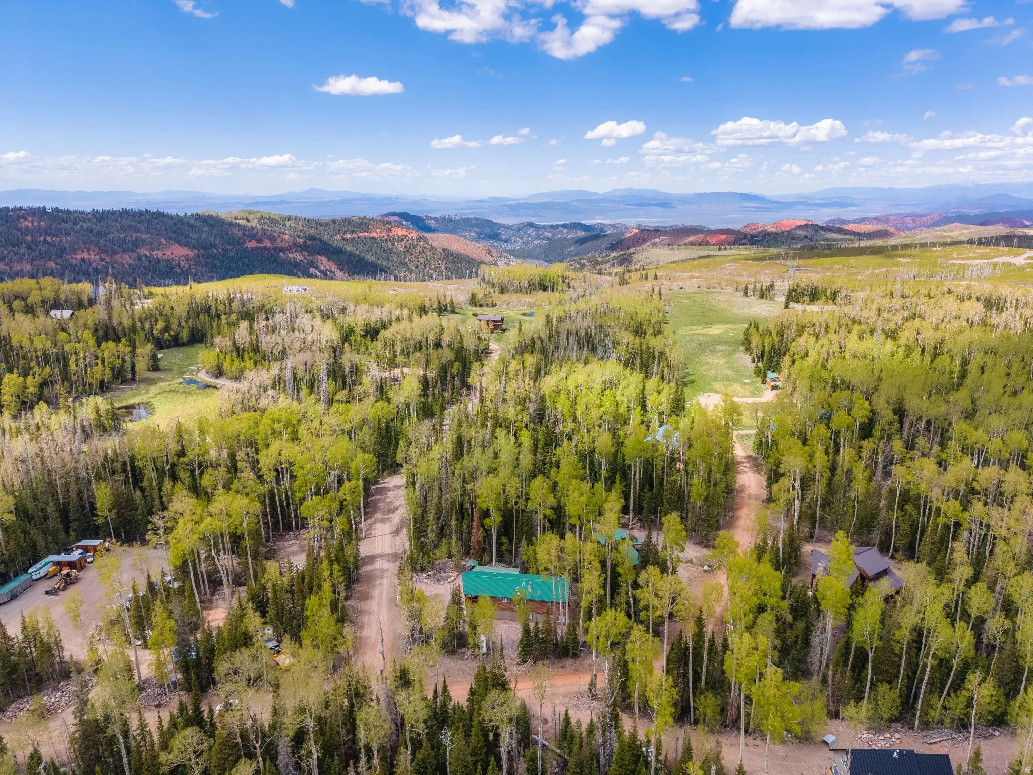 Expansive wooded terrain with scattered residential structures