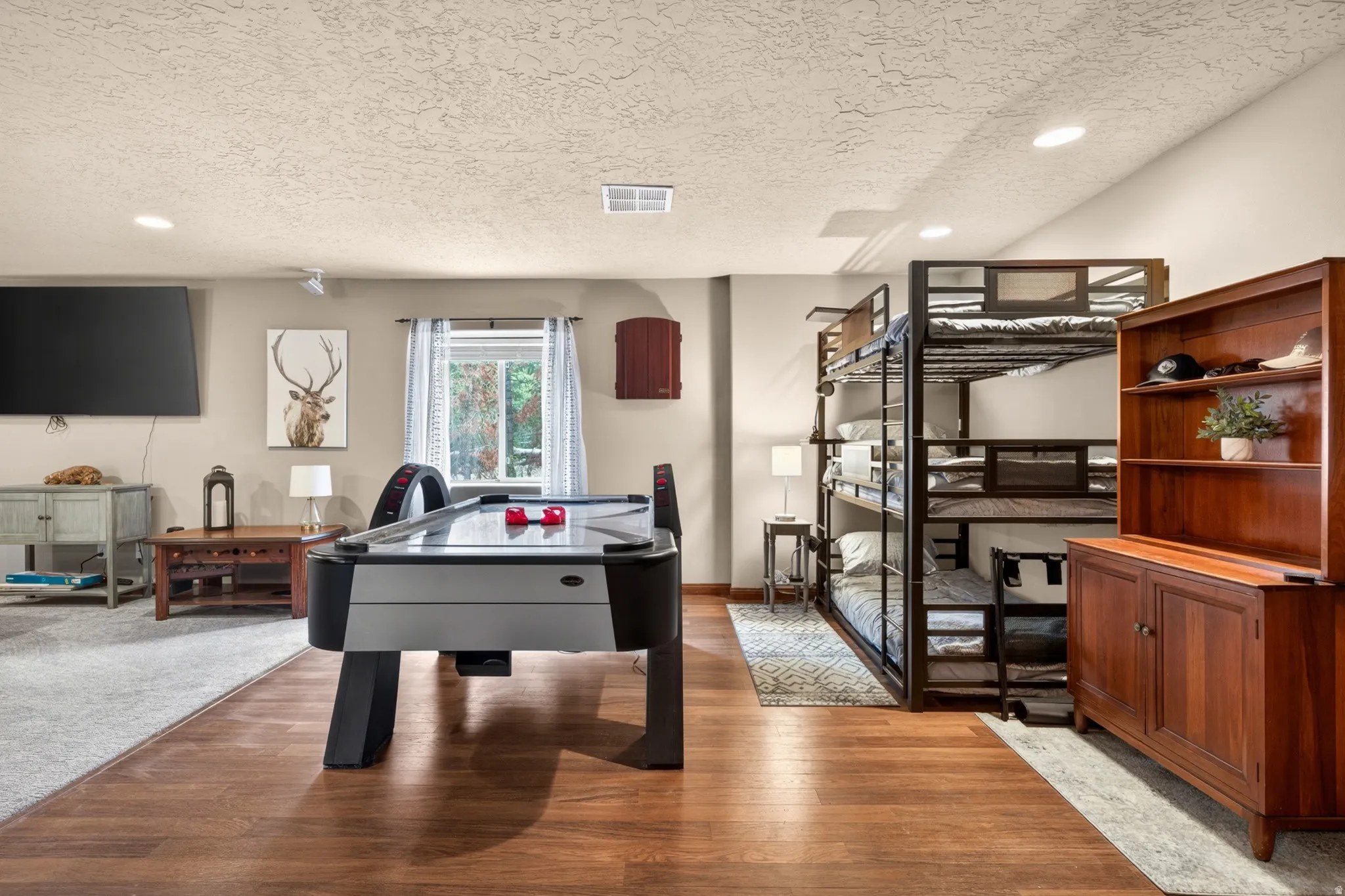 Lower level featuring wood-finish flooring, recessed lighting, and a window with outdoor tree scenery