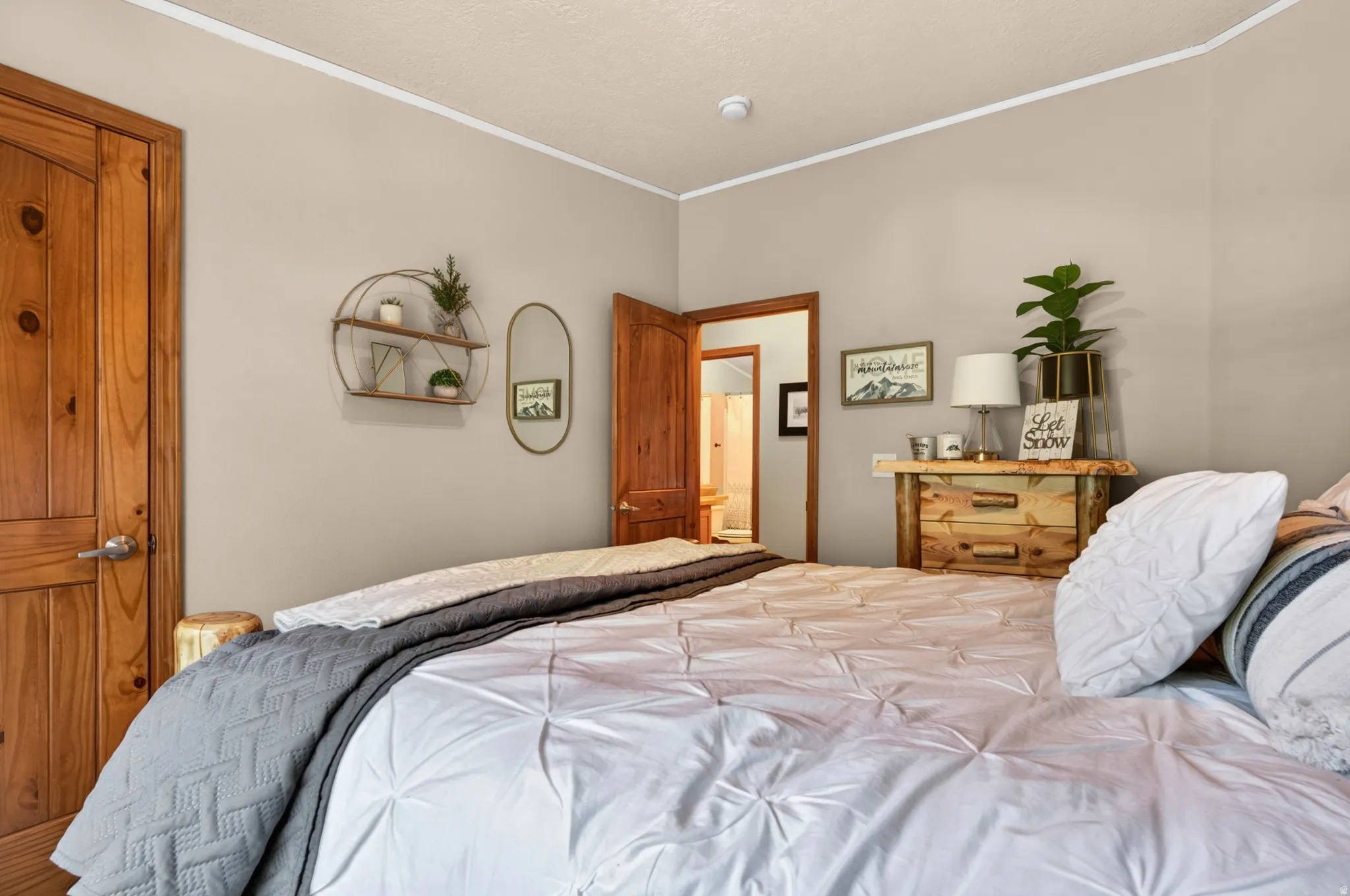 Interior space featuring wood-finish doors and trim, light neutral wall paint, and white crown molding
