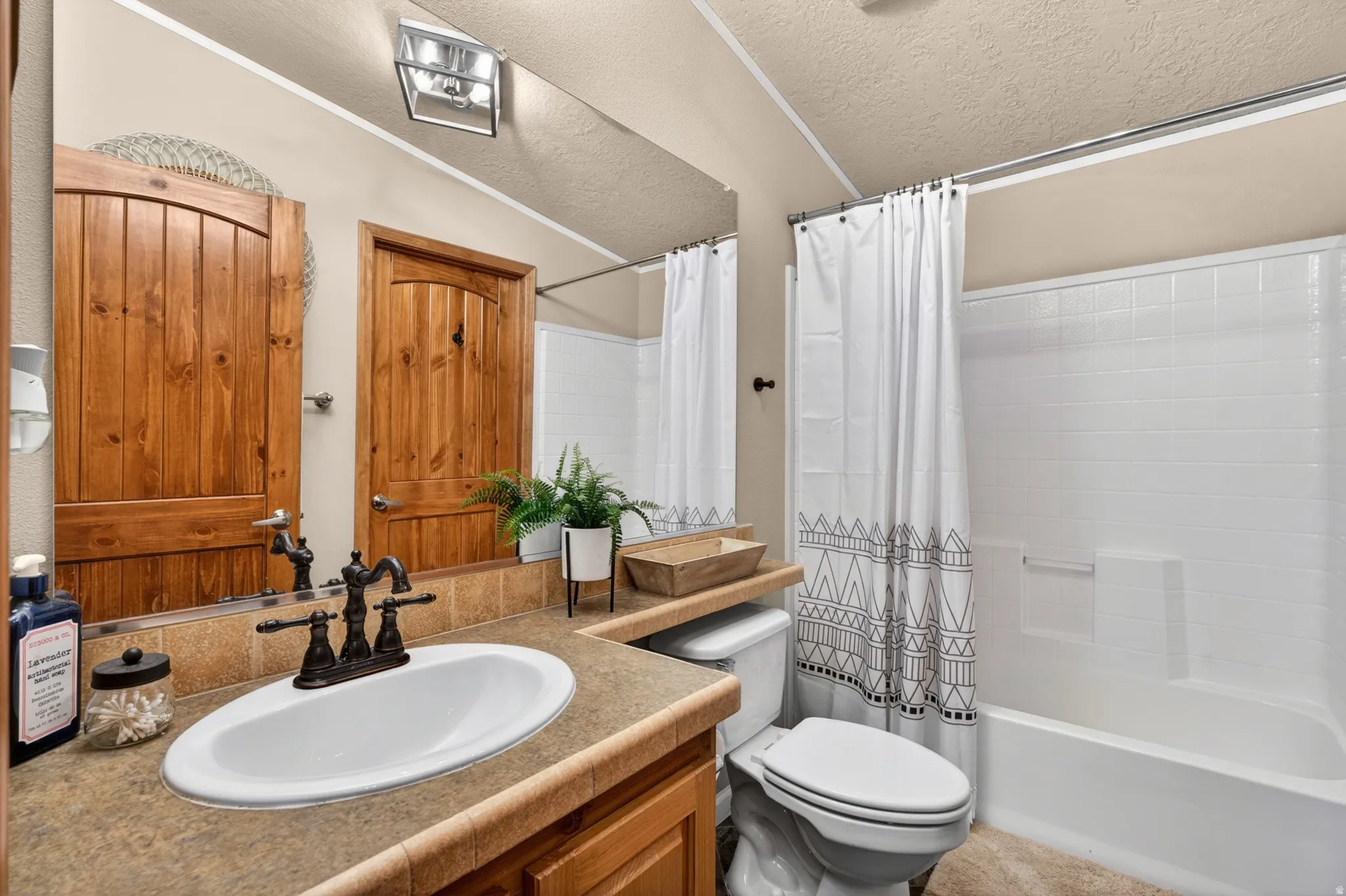 Bathroom featuring a built-in vanity with an integrated sink and oil-rubbed bronze faucet
