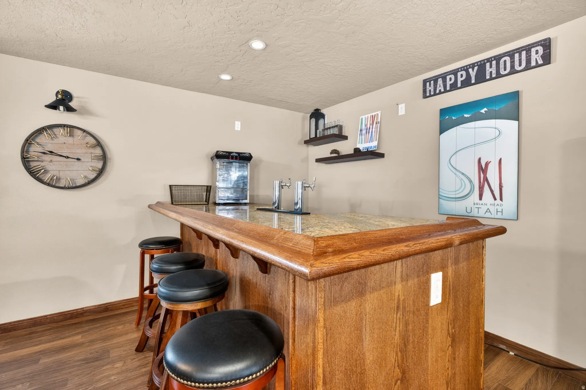 Built-in bar with wood-finish paneling, granite-style countertop, and integrated tap system