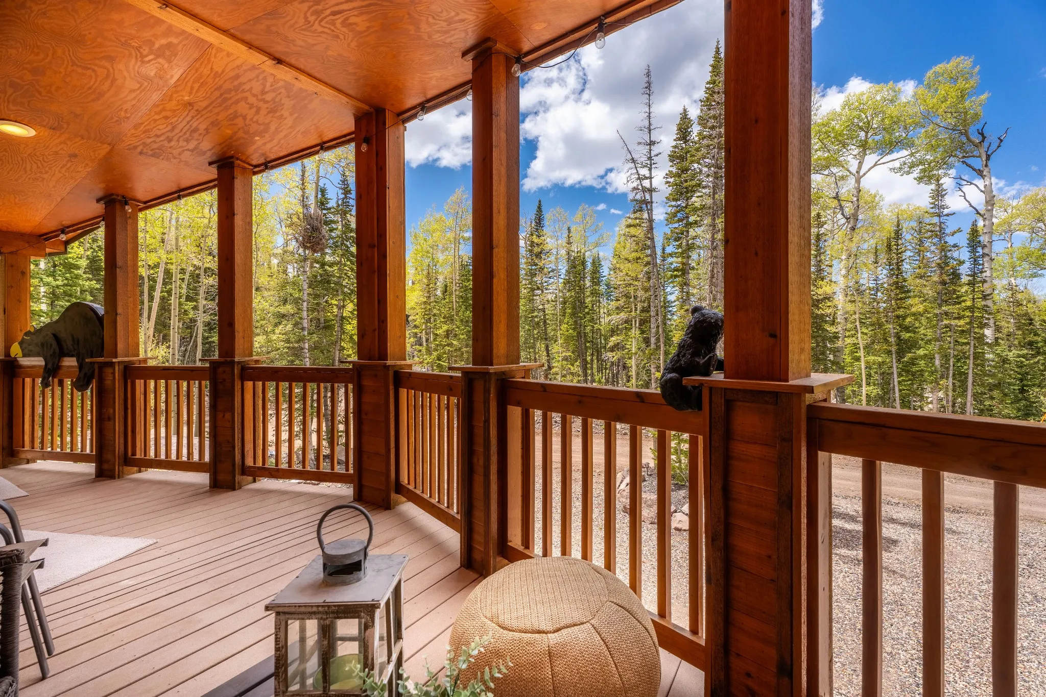 Expansive covered porch featuring wood-finish decking and a robust wood railing system