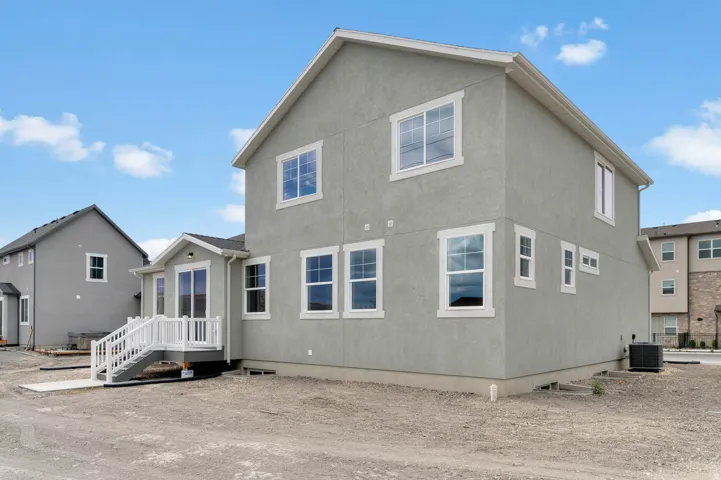 Contemporary stucco exterior with white trim windows