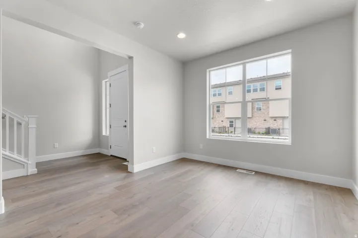 Entryway featuring wood-finish flooring, recessed lighting, white baseboards, and a large multi-pane window