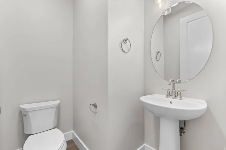 Pedestal sink with brushed nickel faucet and hardware