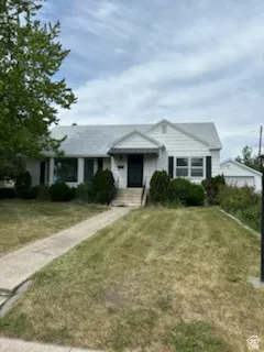 White exterior home with black shutters and a covered entry