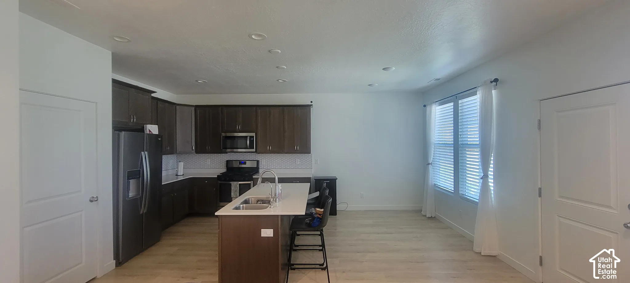 Open-concept kitchen and living area featuring wood-finish flooring