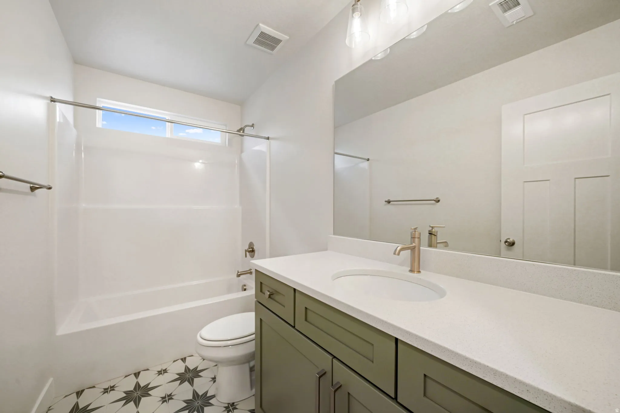 Bathroom featuring a vanity with a white countertop and an integrated sink