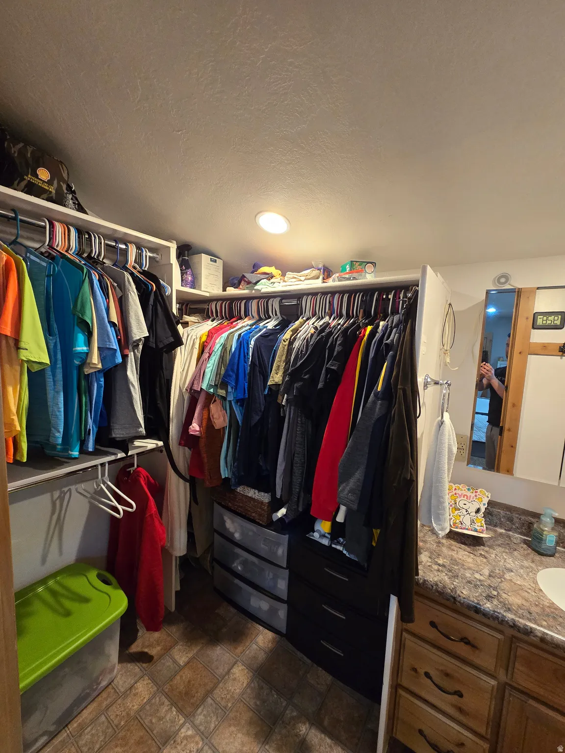 Integrated closet system featuring multiple hanging rods, built-in shelving, and drawer storage
