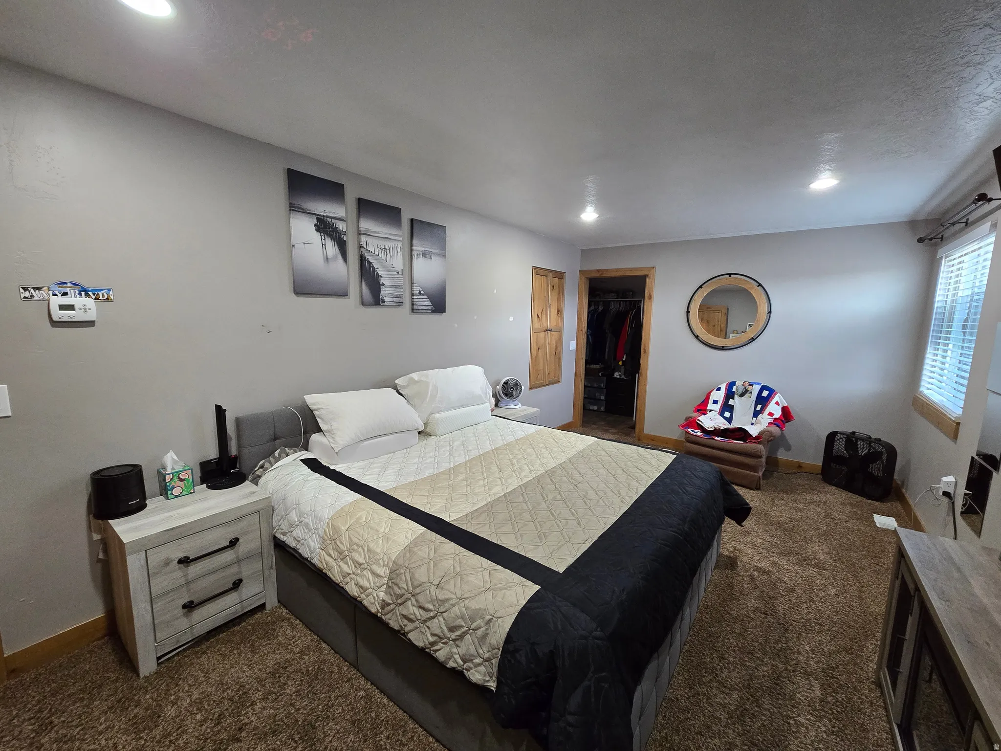 Carpeted room featuring recessed lighting and a window with blinds